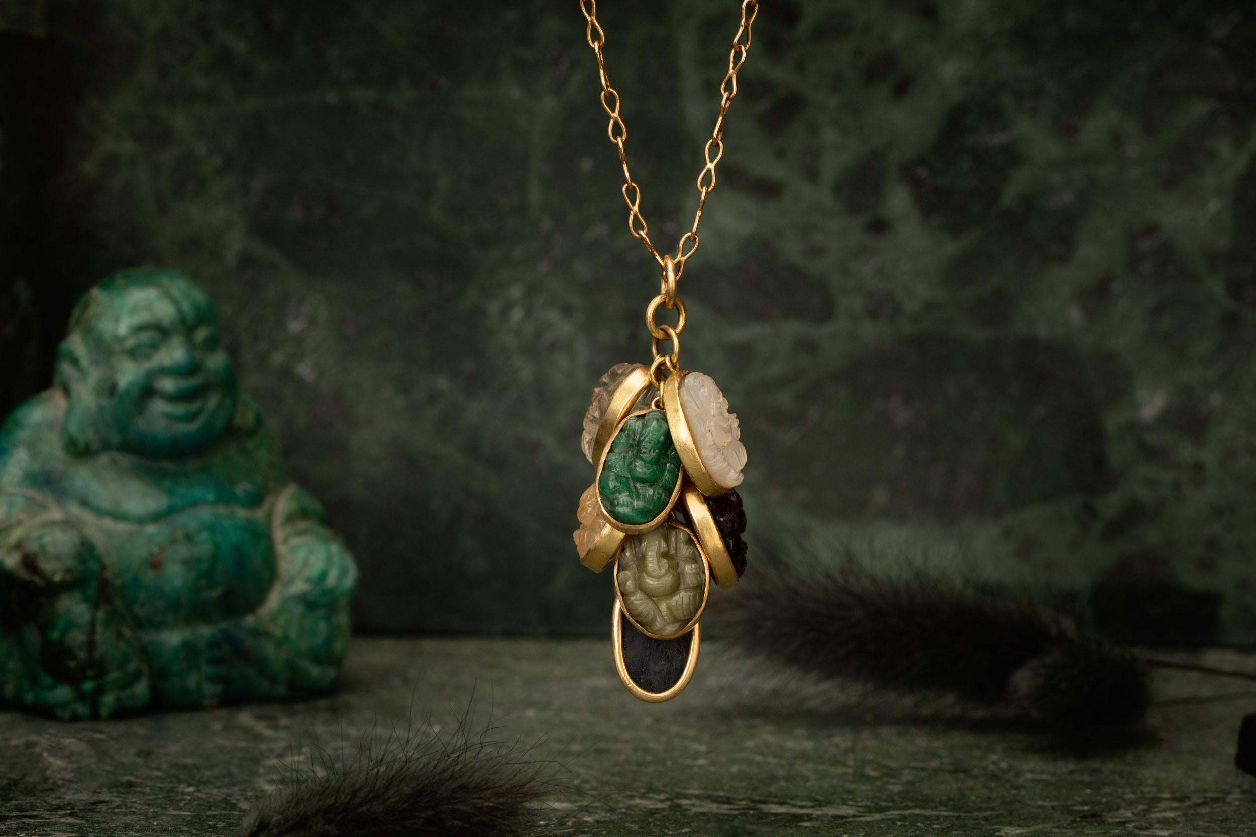 Rough Cut Nine Hand-Carved Ganesha Set in 18 Karat Gold Cascading into a Waterfall Pendant