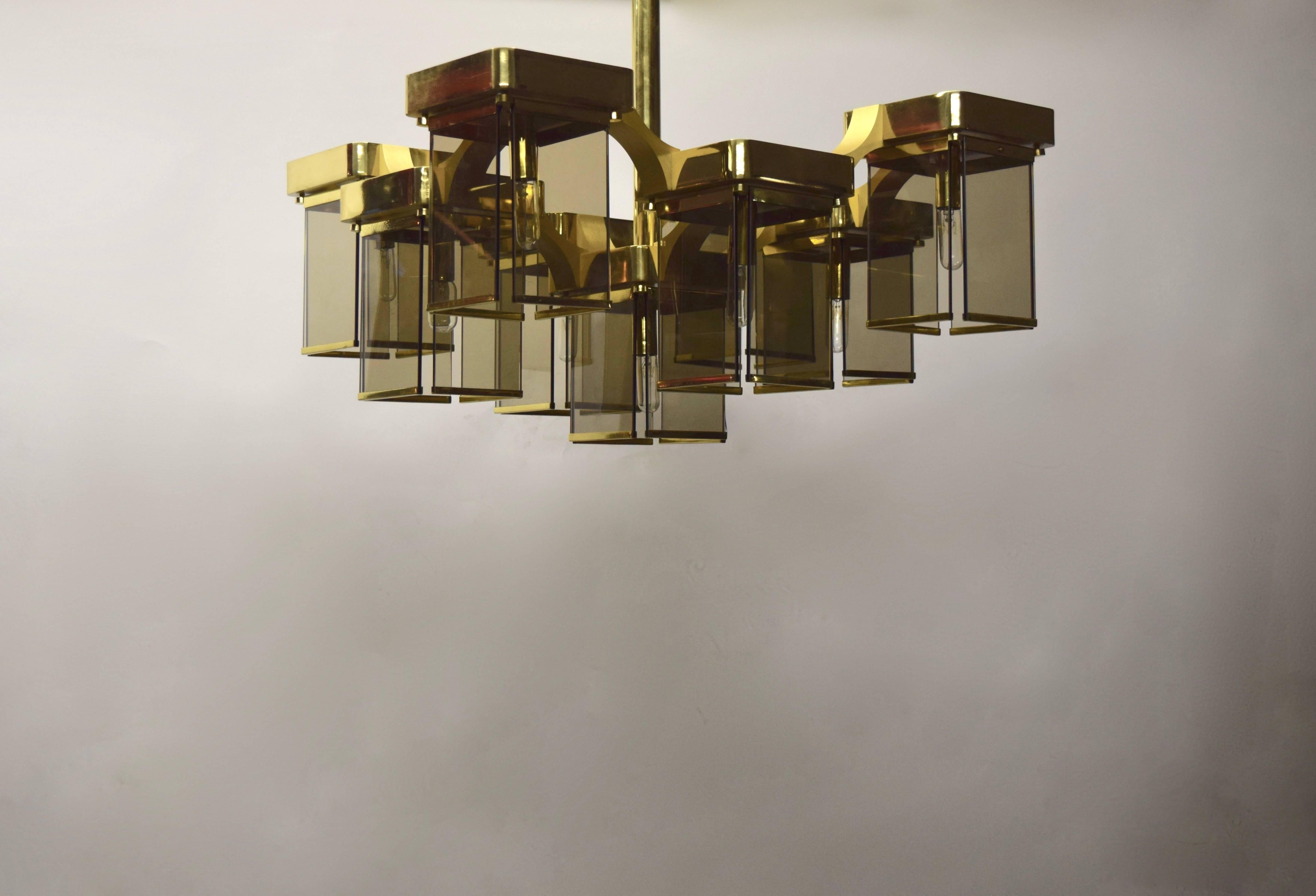 Sciolari ceiling fixture has nine lights and comprises panels of bronze smoked glass and brass plated steel and aluminium hardware. Each light is connected by arching brushed brass finished supports and has one candelabra based socket. 
The