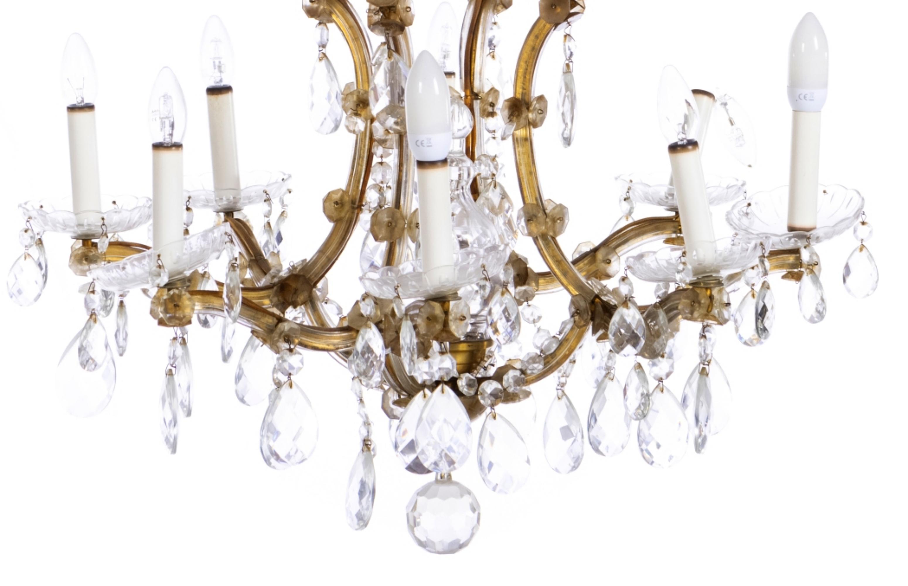 Nine light chandelier
Lighting Category
20th century Portuguese, gilded metal structure, crystal drops and pendants. 
faults 
Dimensions: 77 x 79 cm
Good condition.