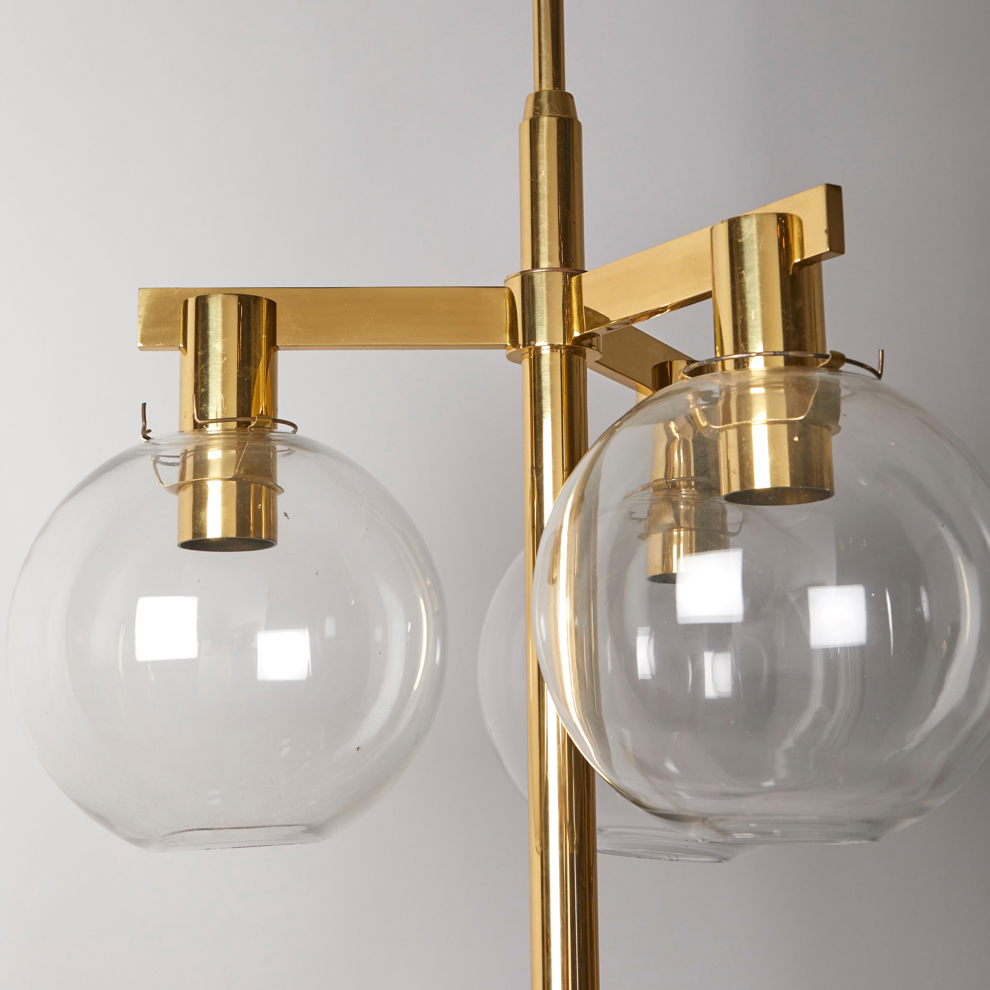 A rare nine-light contemporary design celling fixtures designed by Hans-Agne Jakobsson (1919–2009). The brass frames with light patina and lacquered finish having clear glass globes, each concealing a medium socket. Circa 1970.  Provenance: Rydaholm