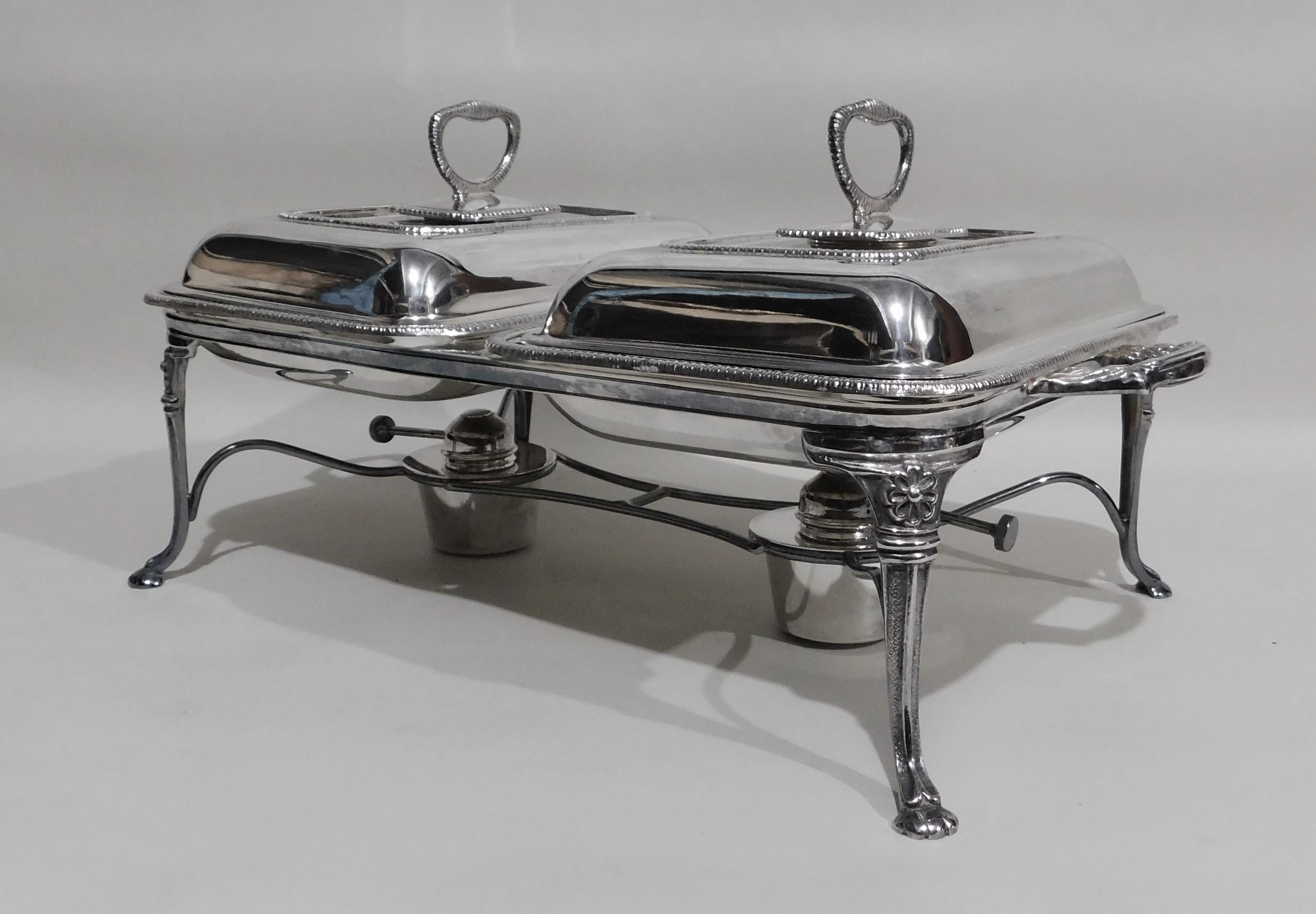 Stamped Yore Plate E.P.N.S. Made in England 8130 silver plated double entree warmer serving dish, circa 1950. Consists of four-footed base, four trays, 2 burners and two handled lids (handles are removable) in very good condition.