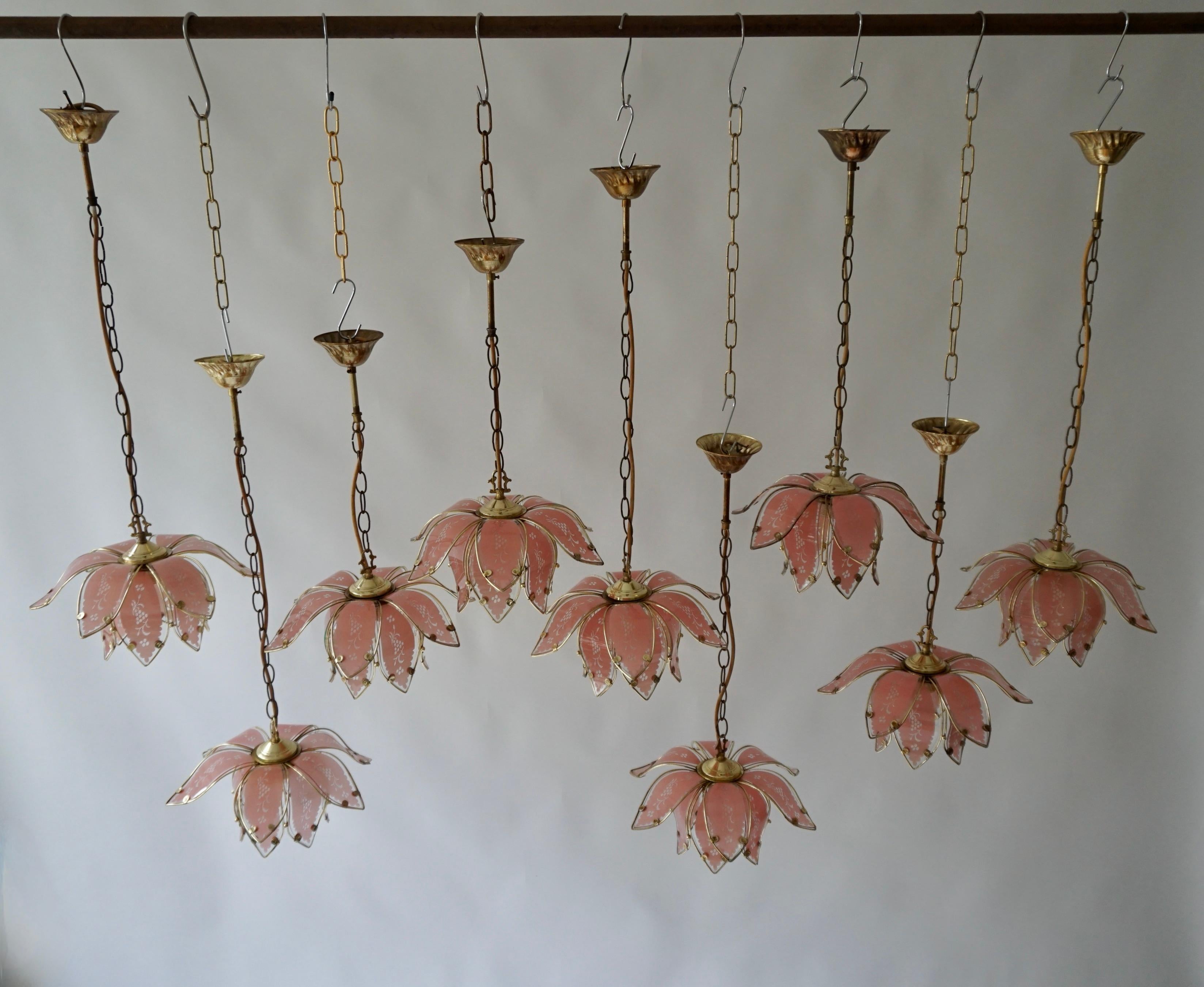 Nine iconic vintage pink lotus flower lamps.

Nine Hollywood Regency ceiling lights from Italy manufactured in the 1970s. It is shaped like a lotus flower and is made of brass plated metal. The lamp has one socket for incandescent lamp with screw