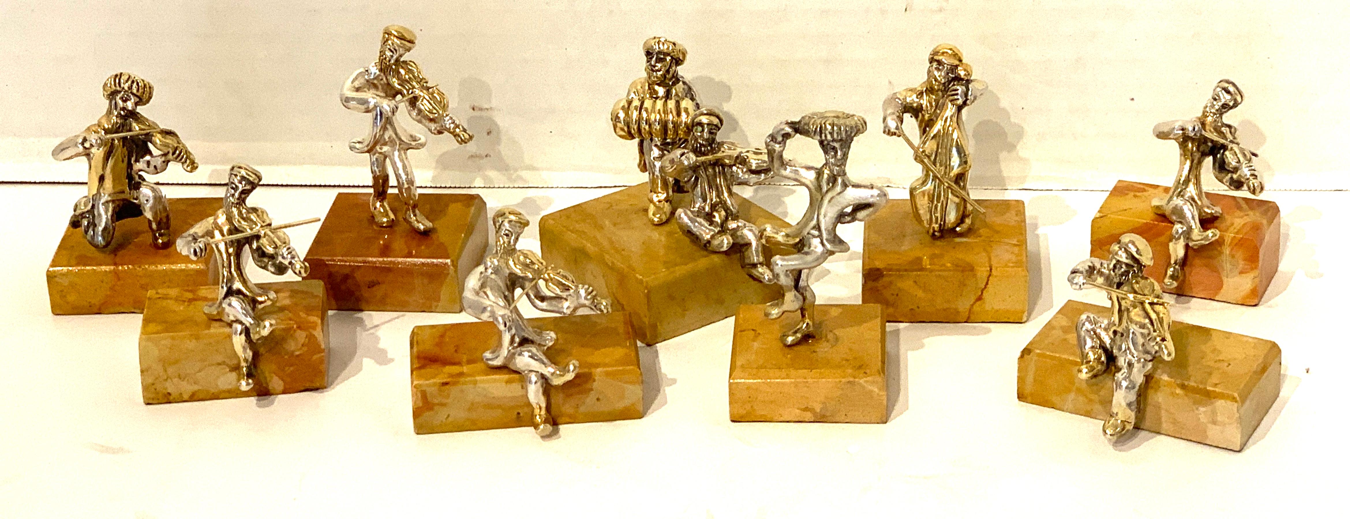 Nine Sam Philipe gilt sterling Judaica sculptures, consisting of one double and eight single sculptures, of various musicians and dancers. Each one realistically cast and modeled, some with gilt vermeil detail, all raised on marble cube bases.