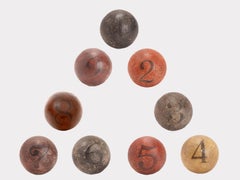 Nine spheres: weighting only twice and try to find the heaviest one, France 1900