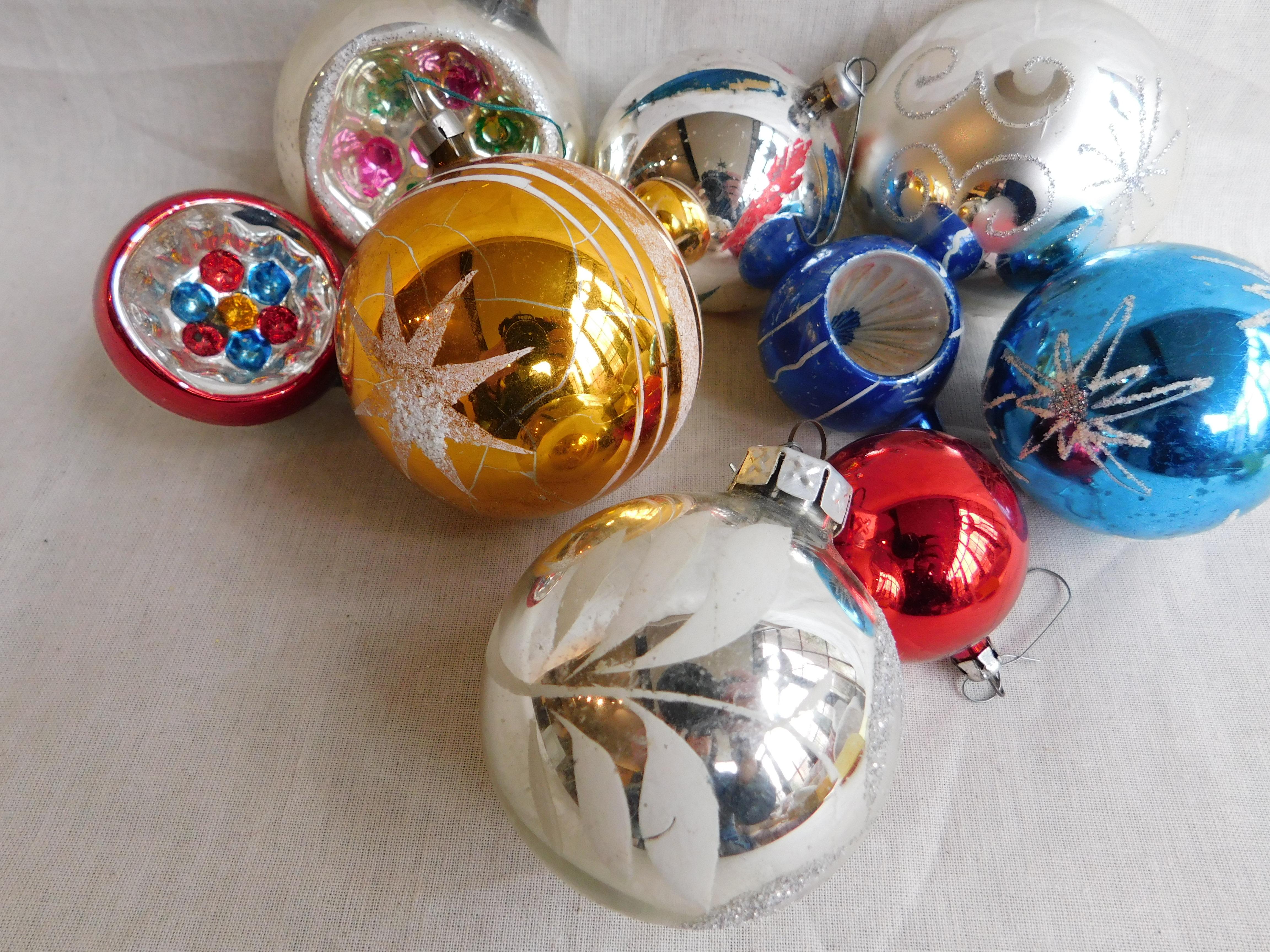 Nine vintage 1 German blown mercury glass Christmas tree ornaments. Fantastic reflections in silver, gold, blue and red, and some with snow glitter,
circa 1960-1970 some of the top caps are marked 