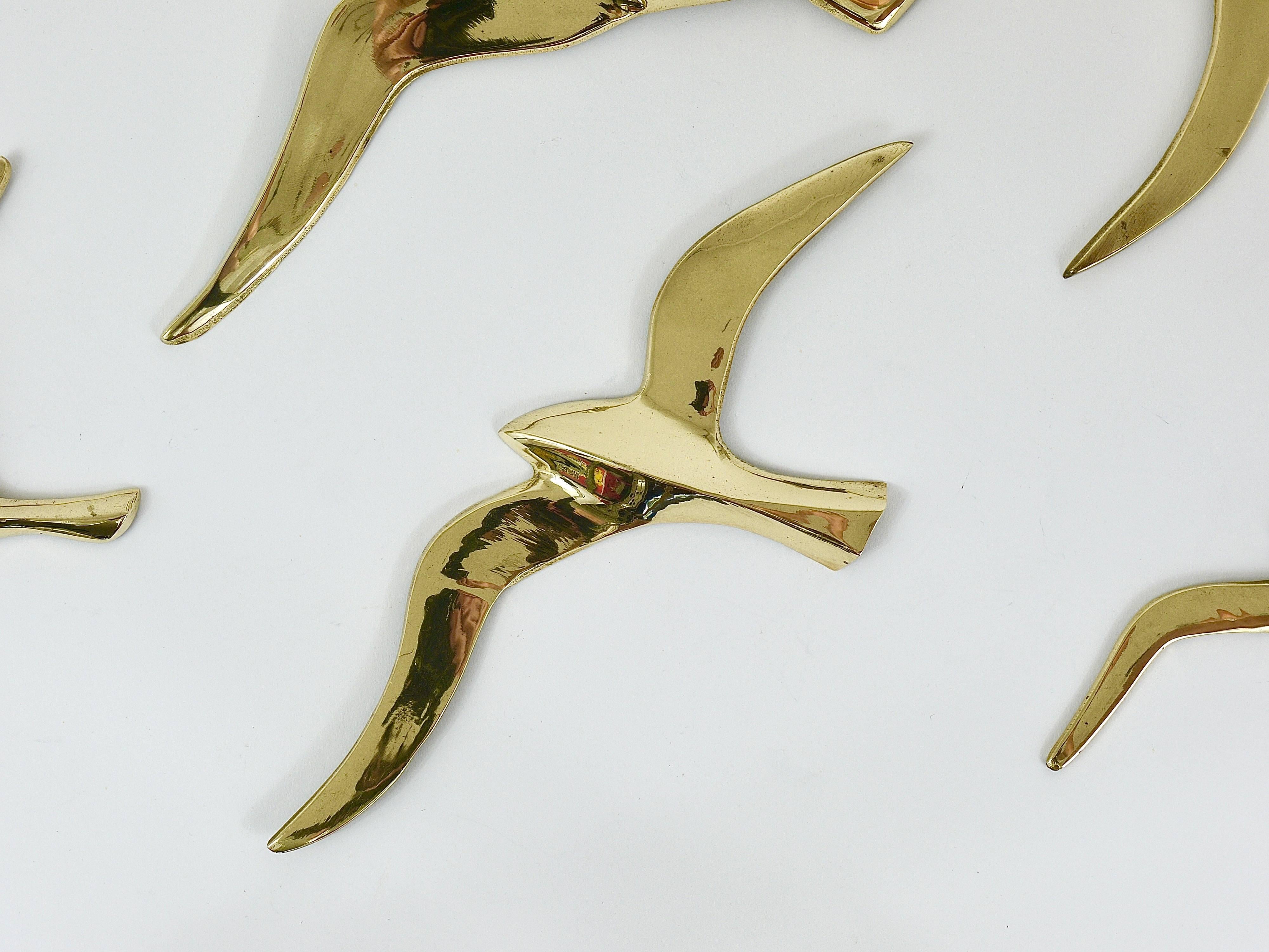 A set of nine lovely wall-mounted modernist birds / gulls. Handmade of brass in the 1950s in Austria. Gently polished, in very good condition with marginal patina. Measures: Width of the birds: 14 to 8 in.