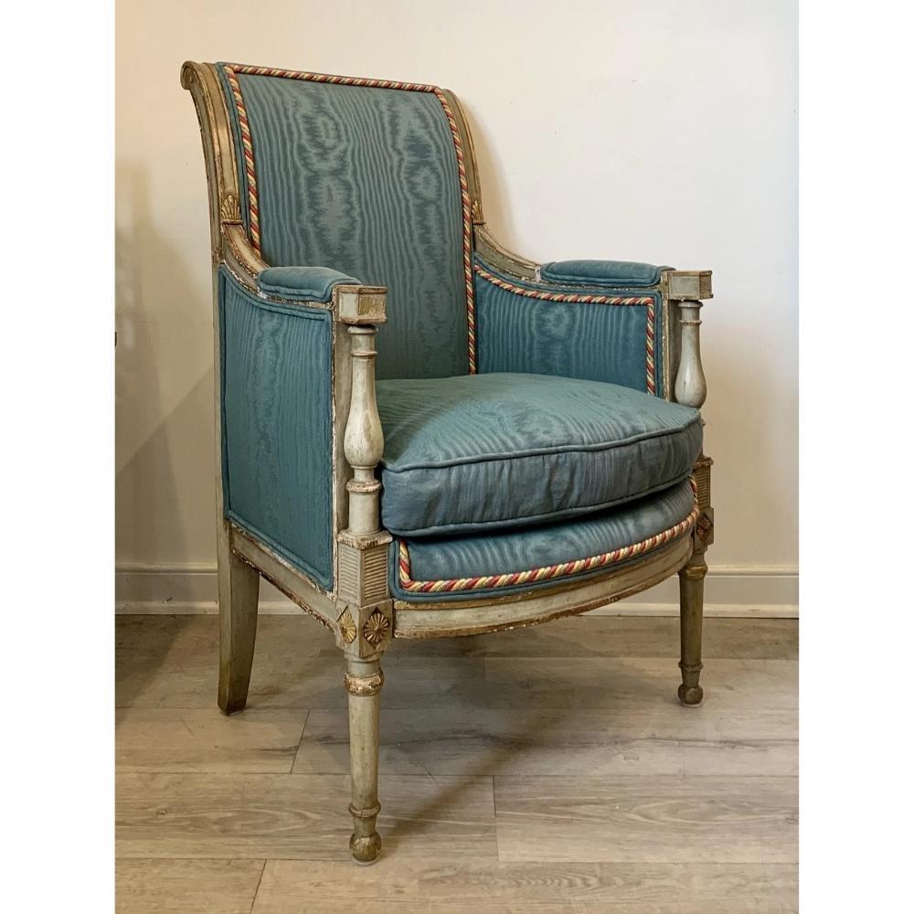 Italian or French polychrome bergère,19th century, likely original celadon green paint with gilt highlights, later moire style teal upholstery with a loose down-filled cushion on ring turned and tapered front legs.
Measure: seat height 17 in.


