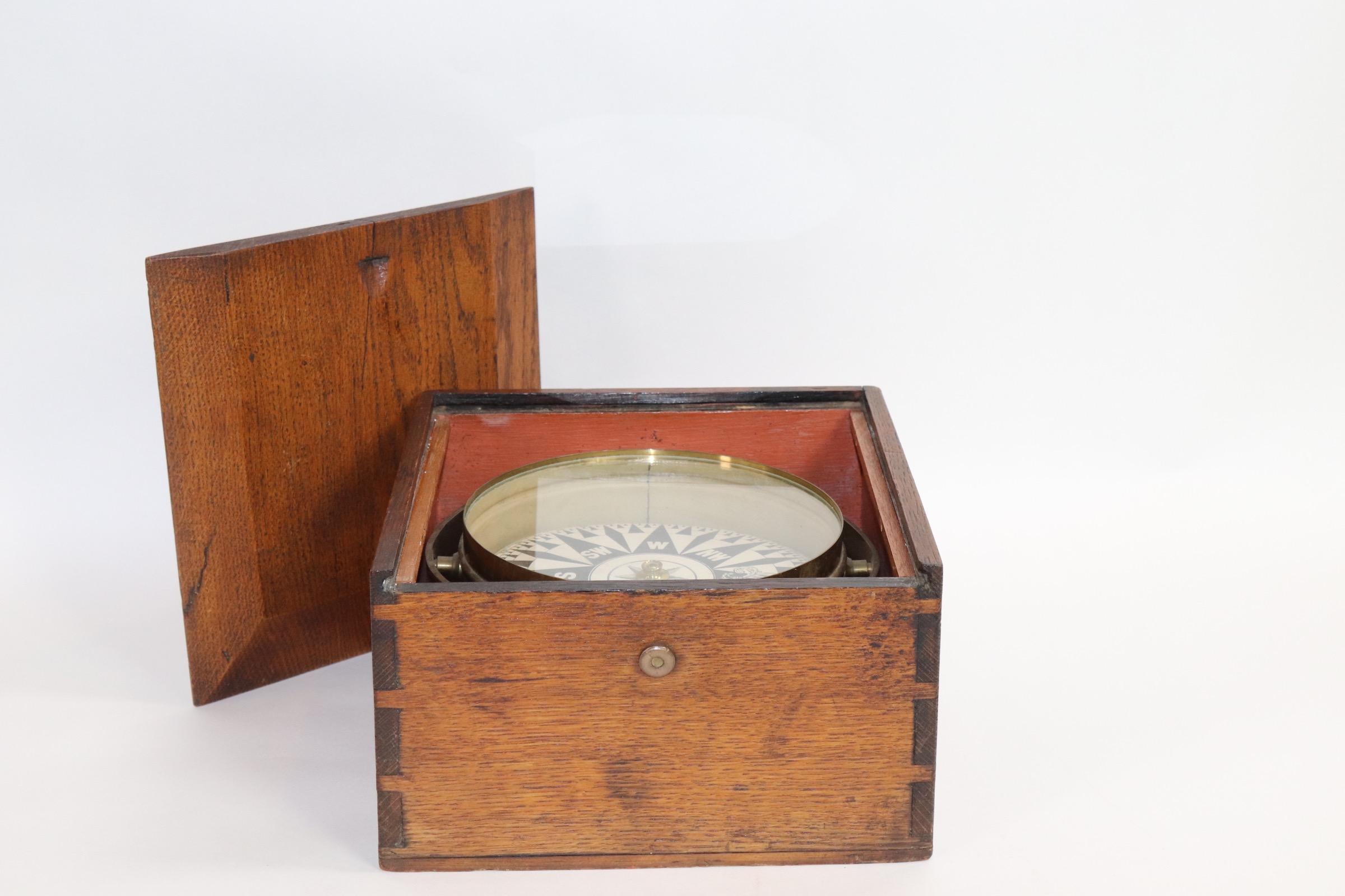 19th century ships compass set into a dovetailed box with sliding lid. Brass bowl compass with gimbaled. Weight is 9 pounds.