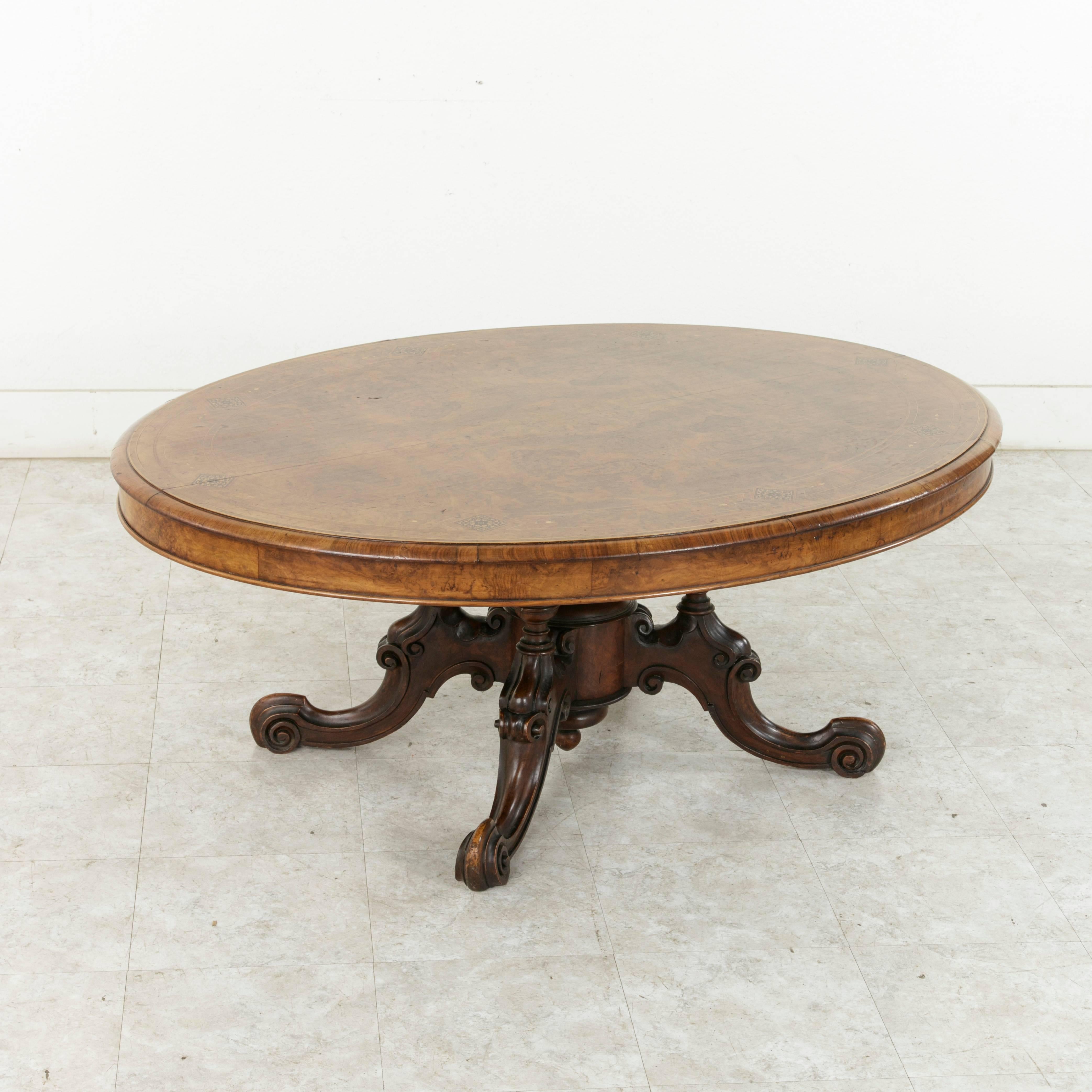 The English loo table is a model table from the 18th and 19th centuries, originally designed for the card game loo, which was also known as lanterloo. This Fine example from the Victorian age features a bevelled oval top of burl walnut inlaid with