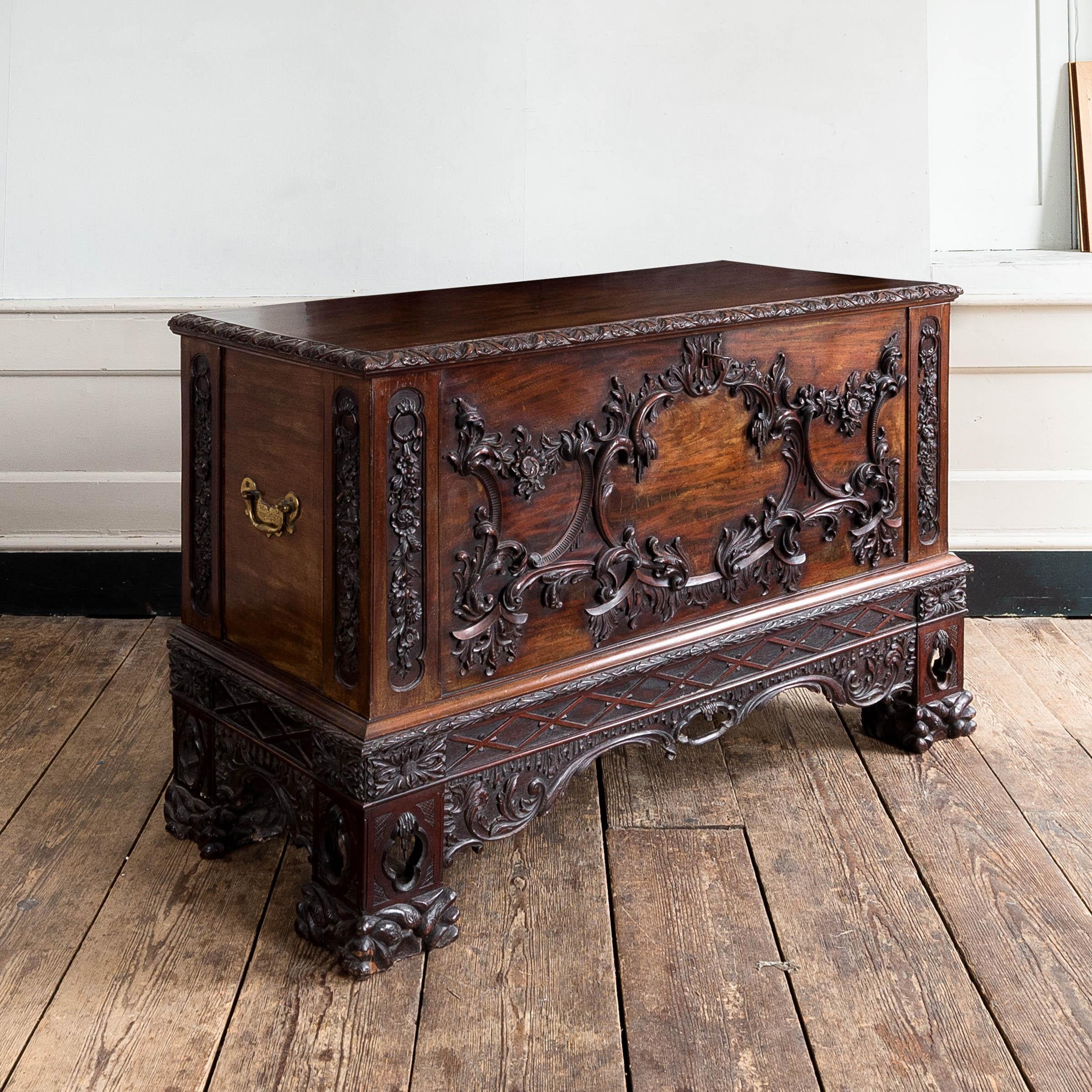A fine and exuberantly carved mahogany chest, a nineteenth century interpretation of a mid-eighteenth century design by Thomas Chippendale, see 'Gentleman and Cabinet-Maker's Director', 1763, pl. CXXVIII,

The front centred by a cartouche composed