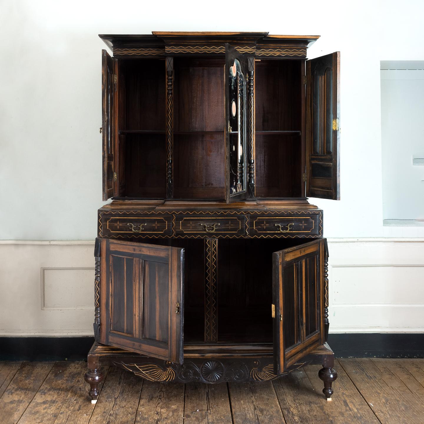 19th century Ceylonese calamander cabinet, Indo-Dutch, the breakfront cornice with zig-zag inlaid decoration to the frieze above central arched mirror door with two further arched doors to either side, each flanked by a pair of half-round turned