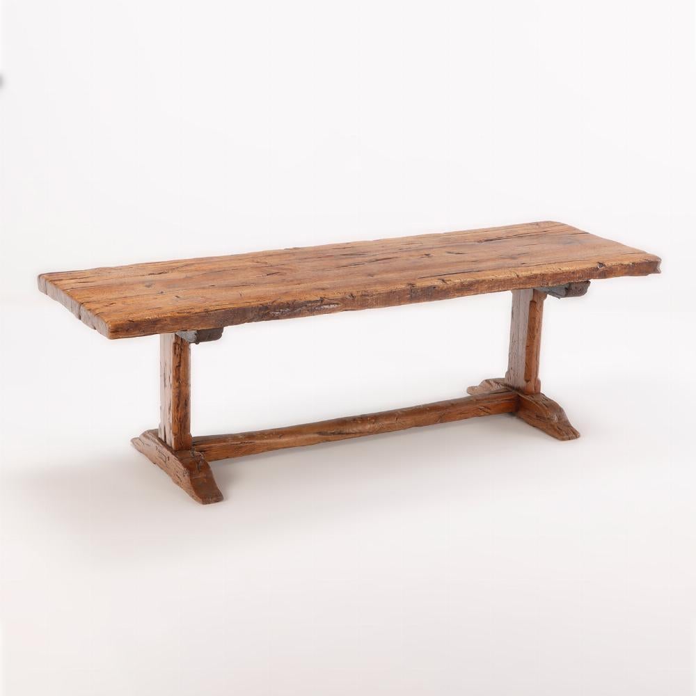 French Provincial Nineteenth century French Elm farm table with trestle base.