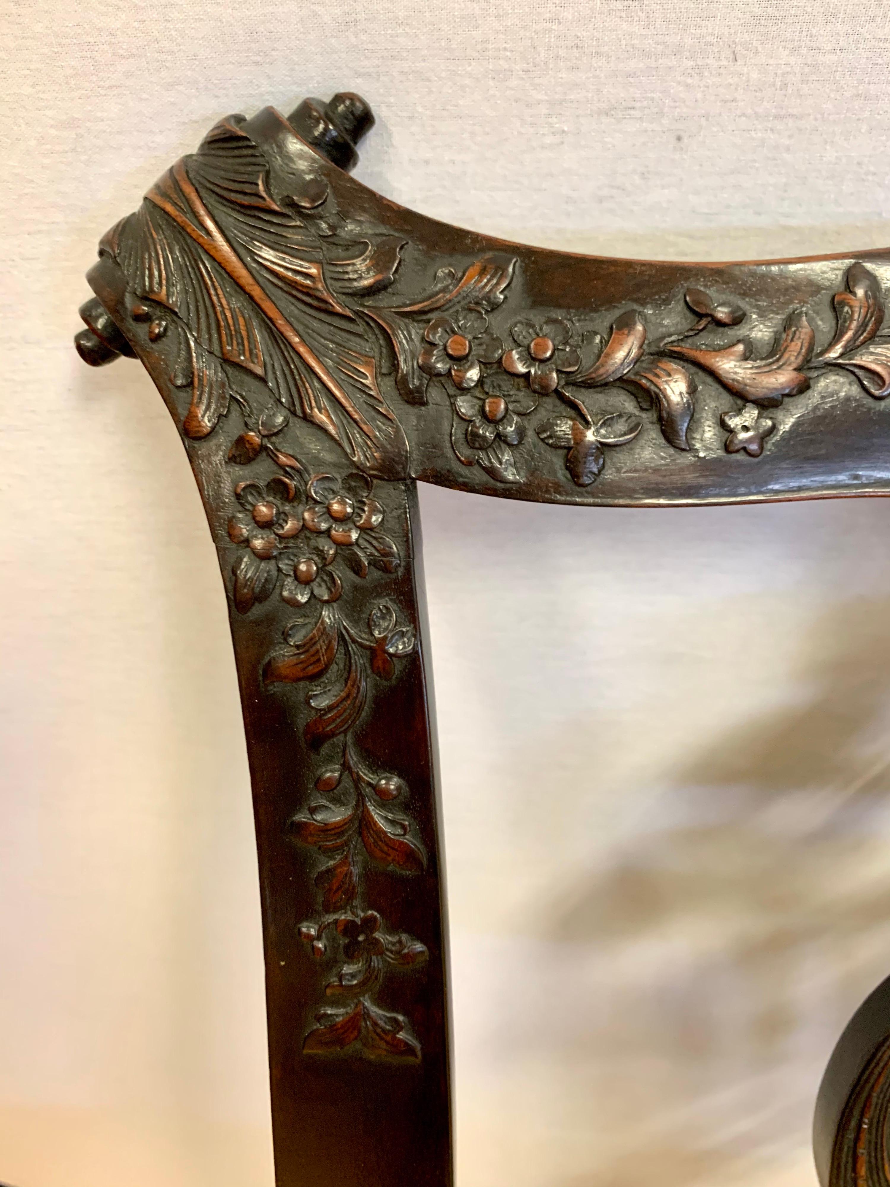 Intricately carved details throughout make this pair of Chippendale George III chairs magnificent.
From the carved shell crest on the seat back to the carved knees and on to the ball and claw feet.
Seats are upholstered in a rich olive green