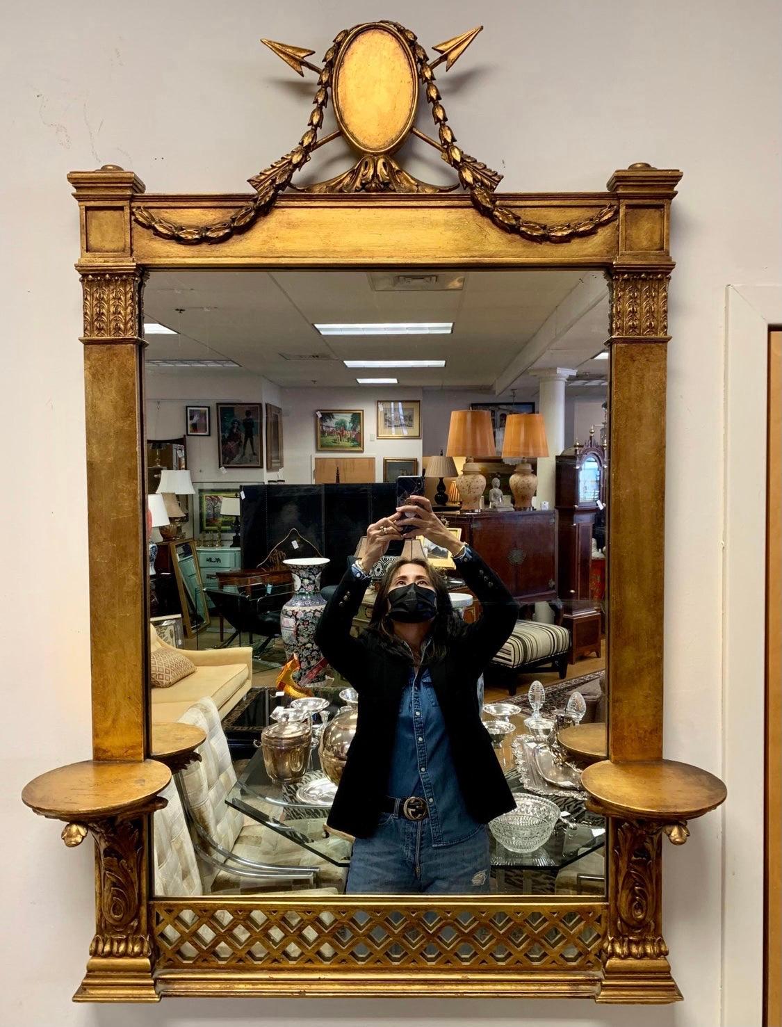 Like none you've ever seen, this Italian beauty from the late 19th century is sure to dazzle. 19th Century Italian mirror with crest featuring a medallion with swags and arrows. Bottom portion of mirror has ornately carved wall brackets on each