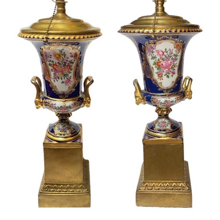 A pair of 19th century French porcelain urns mounted as table lamps with bronze bases.

Measurements:
Height of body: 17
