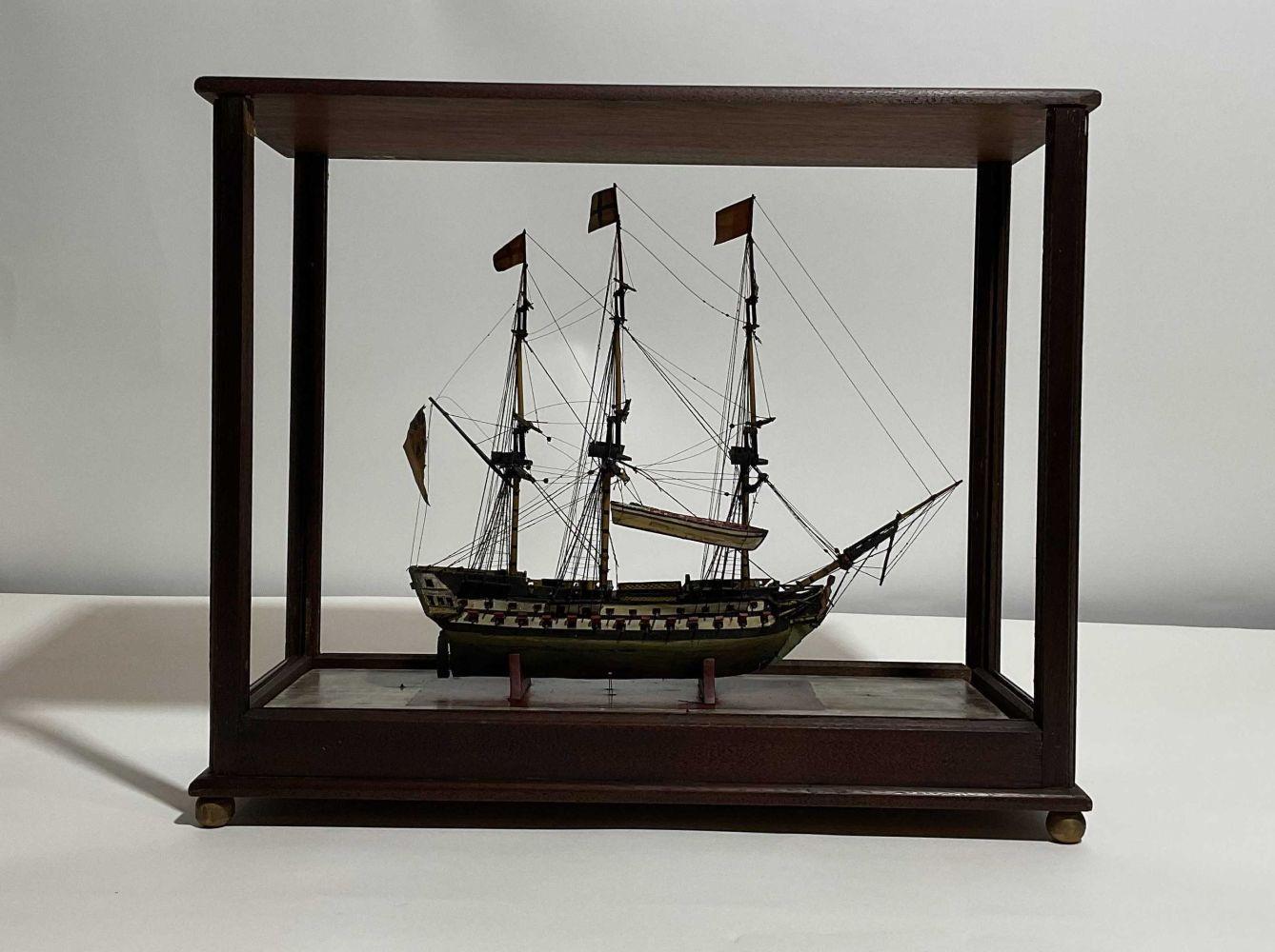 Maquette ancienne d'un navire de ligne anglais. Navire de guerre à trois ponts avec canons, chaloupes, beffroi, figure de proue, drapeaux, etc. Monté dans un étui sur mesure. Petite maquette de bateau antique 12x6x15 H-L-L 5 lbs.