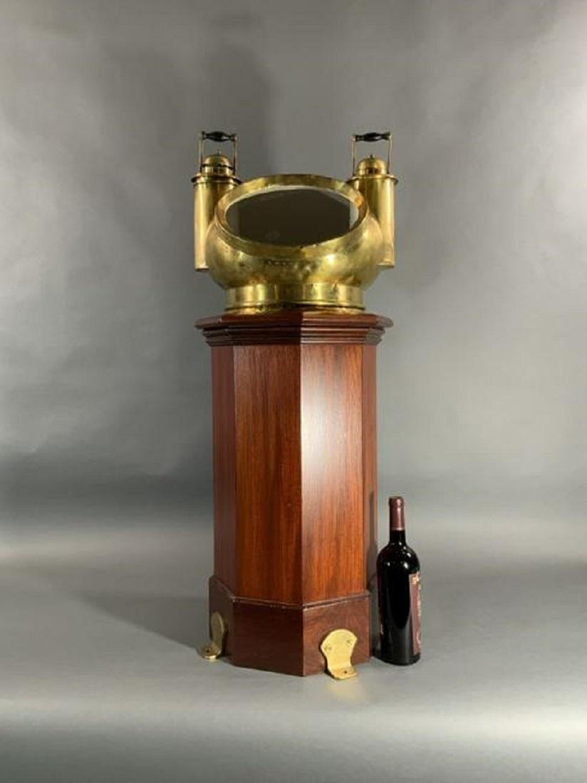 Rare boat binnacle with solid brass mushroom style hood. Mid nineteenth century gimballed compass by Ritchie of Boston. Varnished mahogany base with thick brass tab feet.

Overall dimensions: 39