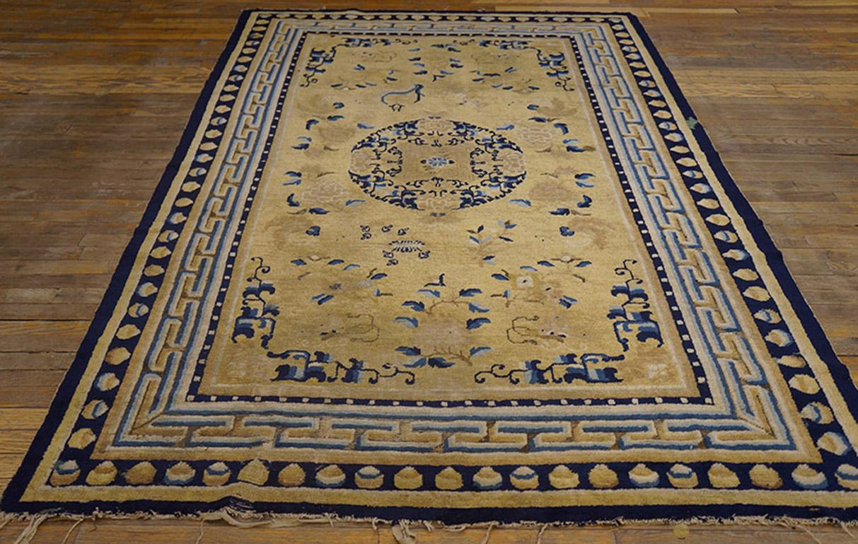 This light yellow-ground Ningxia scatter is a transitional piece between the plain corrosive outer border rugs of the 17th-early 18th centuries and the later all dark blue outer border carpets. The T-fret ribbon style main border has a virtually
