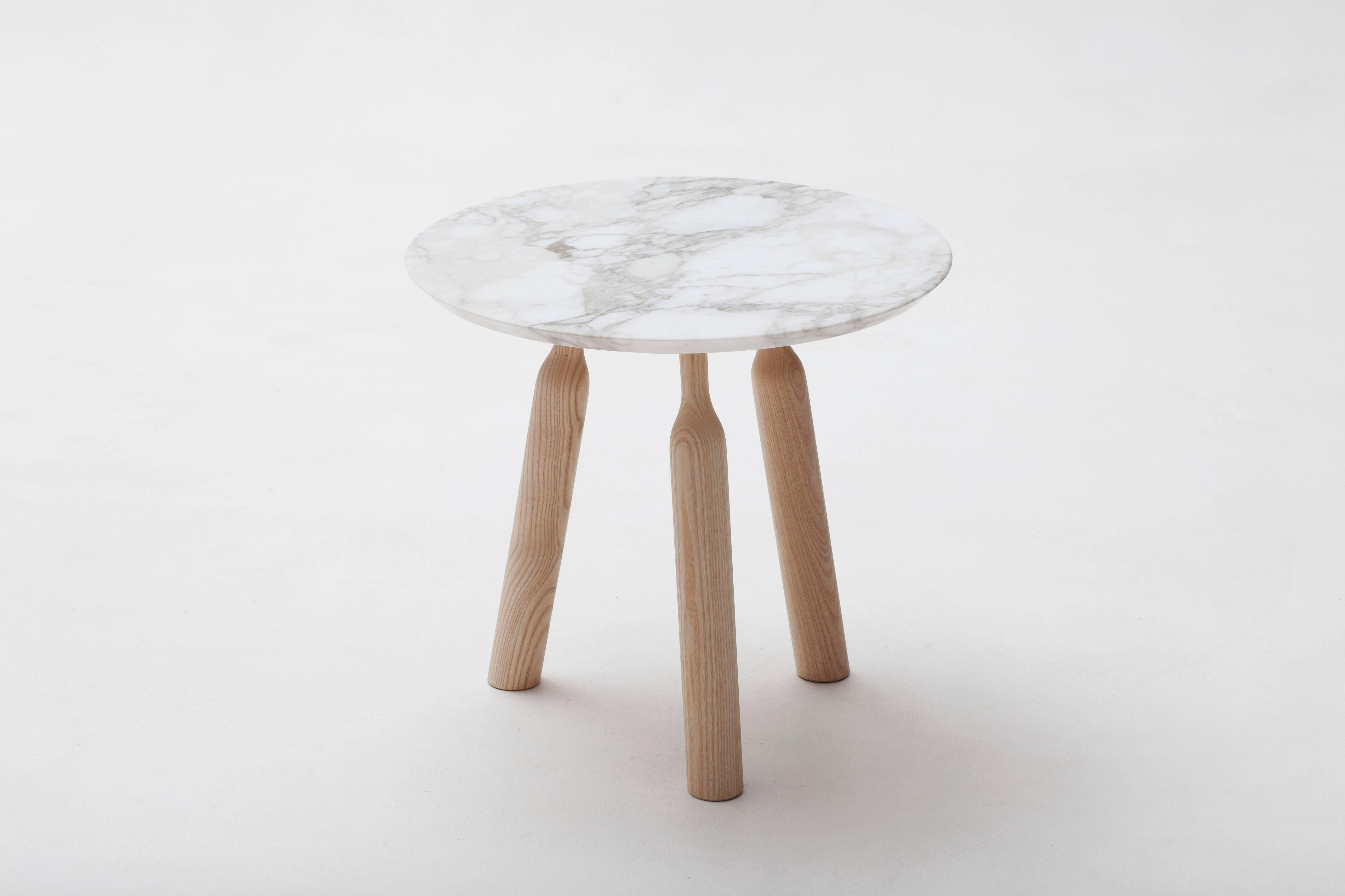 The ultra-chic Ninna side table was designed by Carlo Contin for luxury French furniture brand, Adentro Paris. The Ninna three legs base supports a thin-brushed marble top (marble can be (white) Calataca oro or (dark brown) Emperador. Its structure