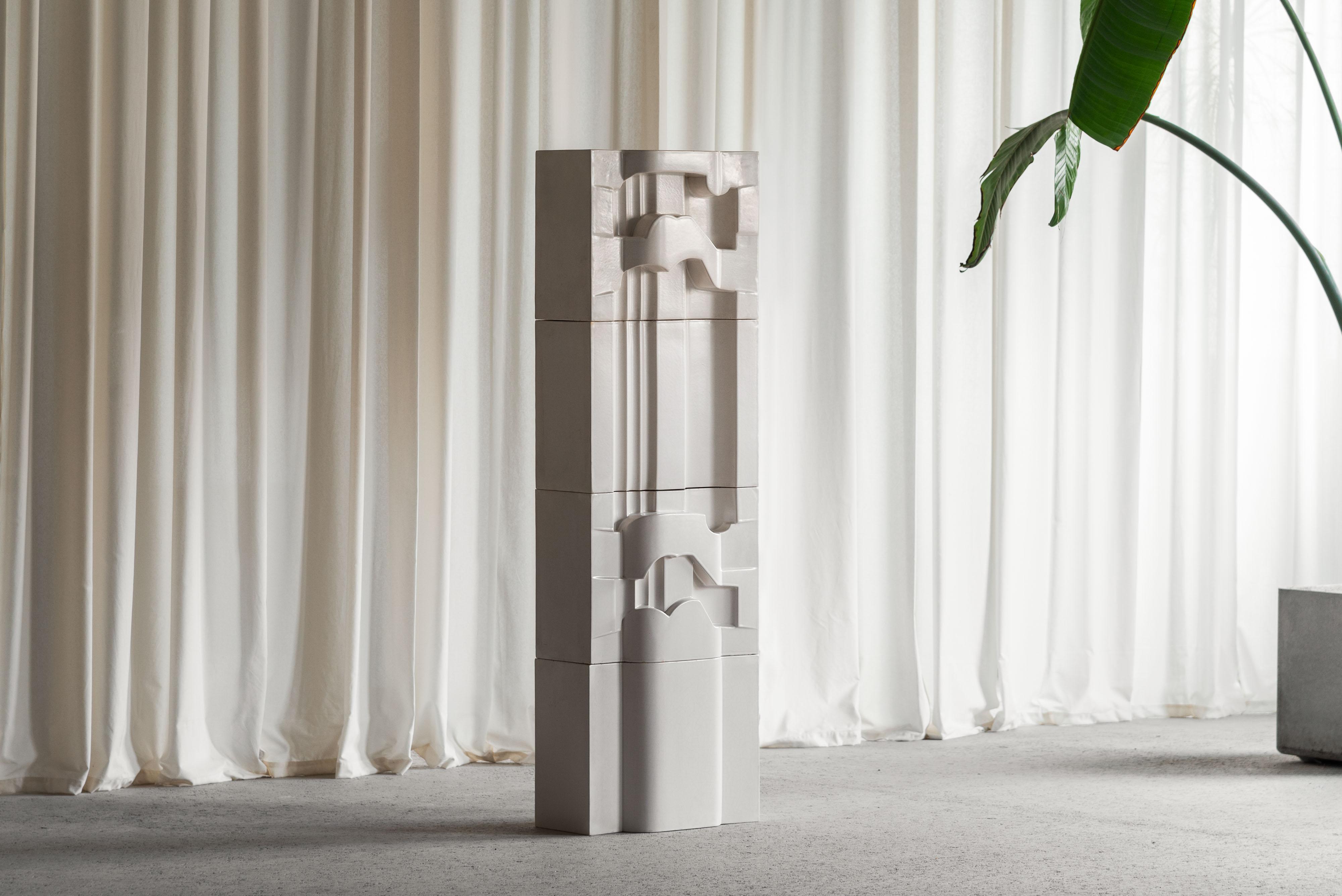 Beautiful modular sculpture made by Nino Caruso in Italy in 1974. This sculpture is made of cream white glazed ceramic. It has four different shapes stacked as a puzzle together, creating a cool architectural look. The sculpture has a nice off-white