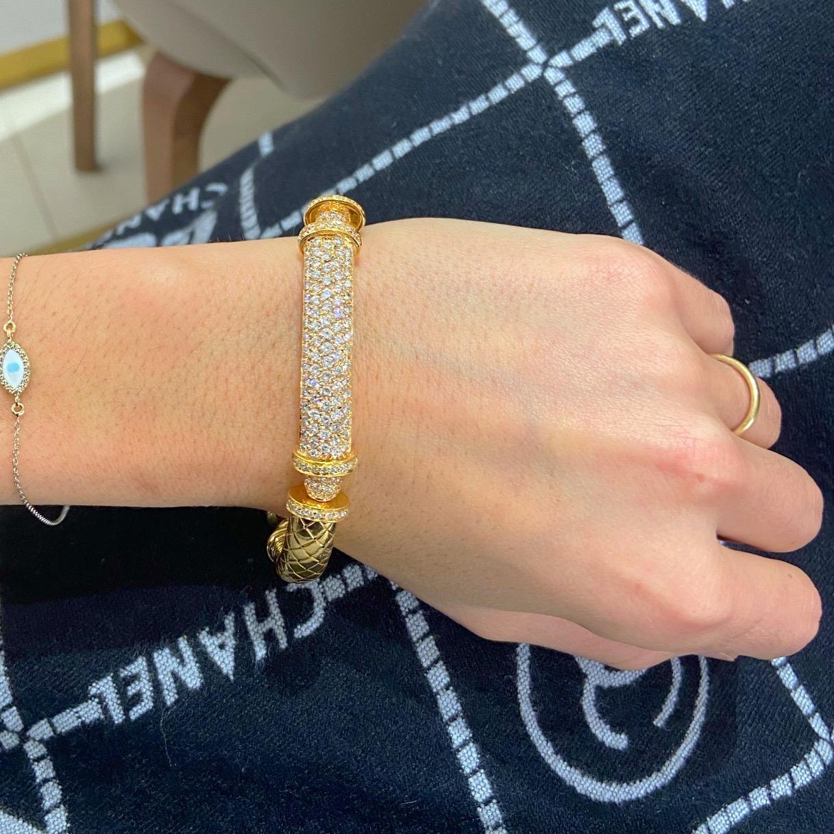 Gorgeous 18 karat pink gold bracelet. This bracelet is designed with four gold sections. The center is beautifully set with 5 rows of round brilliant diamonds. Two pave diamond rondelles accent the center section. The remaining gold sections have