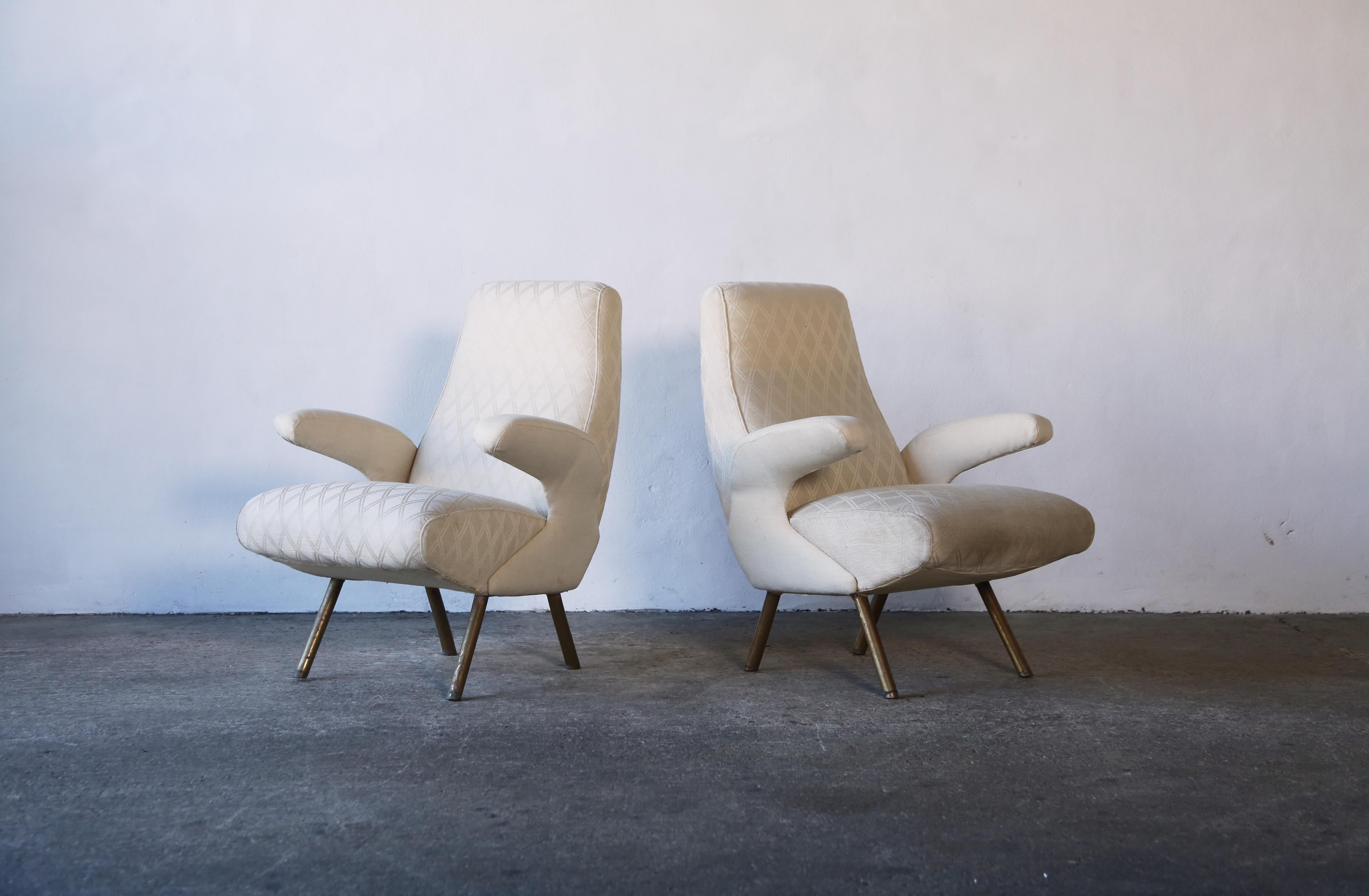 An pair of Nino Zoncada attriuted lounge chairs, Italy, 1950s. The fabric has marks and the filling is slightly tired so these chairs are sold for reupholstery by the customer in their own choice of fabric.  Fast shipping worldwide.
