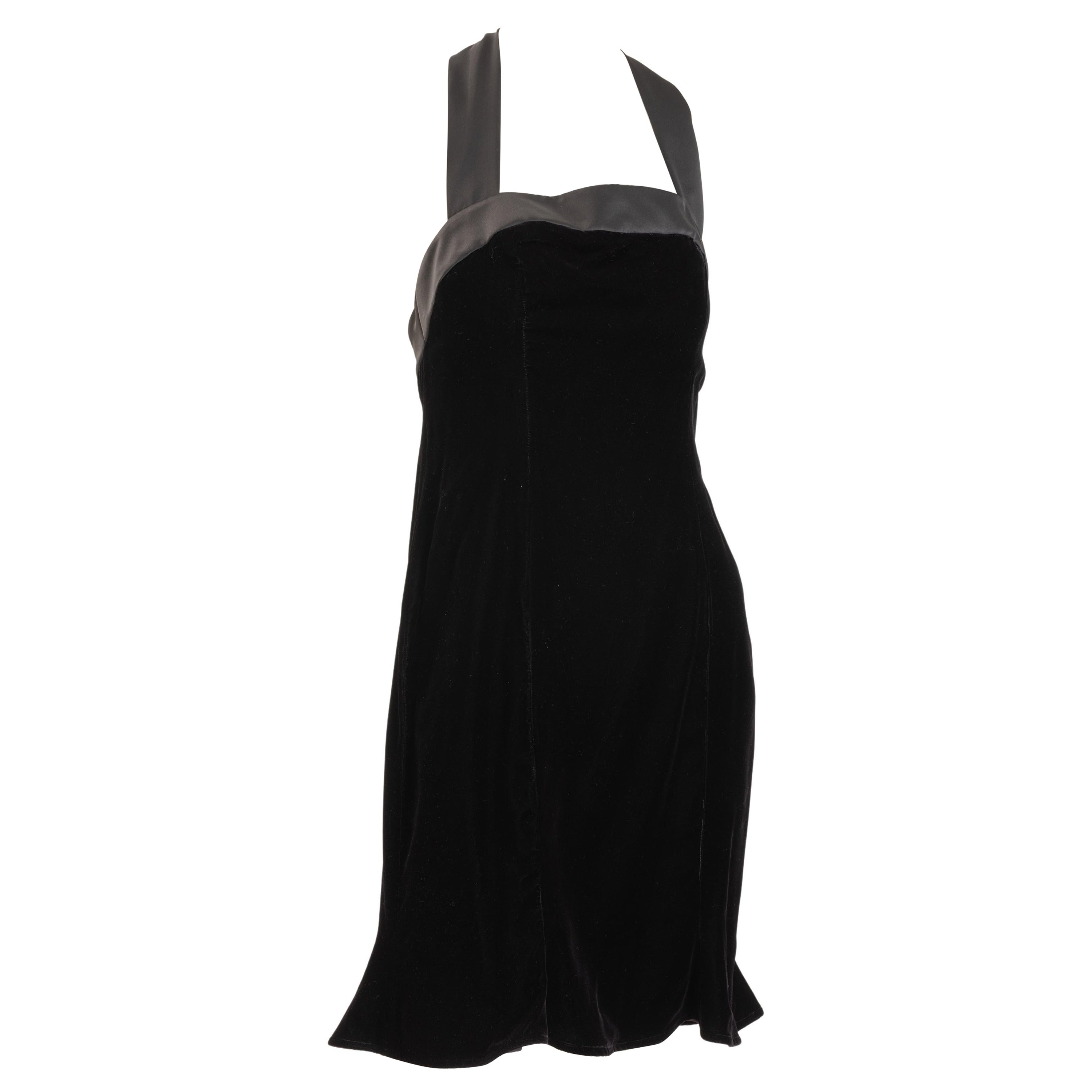 Nipon Boutique black velvet cocktail dress with satin ribbon trim and bows tied at neck and back.
 Flirty six paneled dress body with flared bottom.  Fully lined. Size US 6
Labeled, Nipon Boutique  65% Acetate 35% rayon velvet .