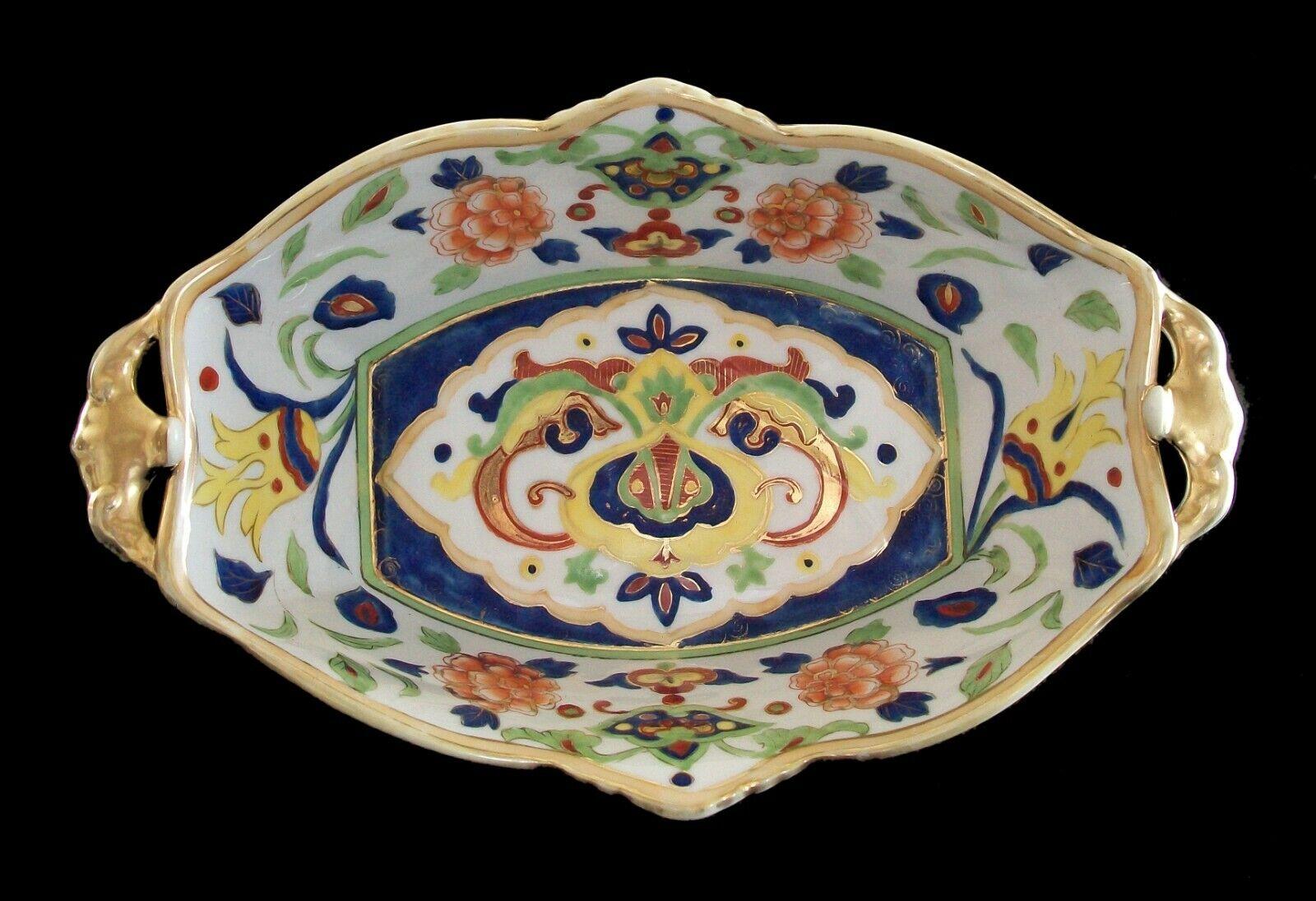 NIPPON - MORIMURA BROTHERS (Manufacturer) - Antique hand painted ceramic center bowl - rare design featuring flowers and arabesque scrolls in the Persian style to the interior - molded panels to the exterior with painted flowers - gilded handles and