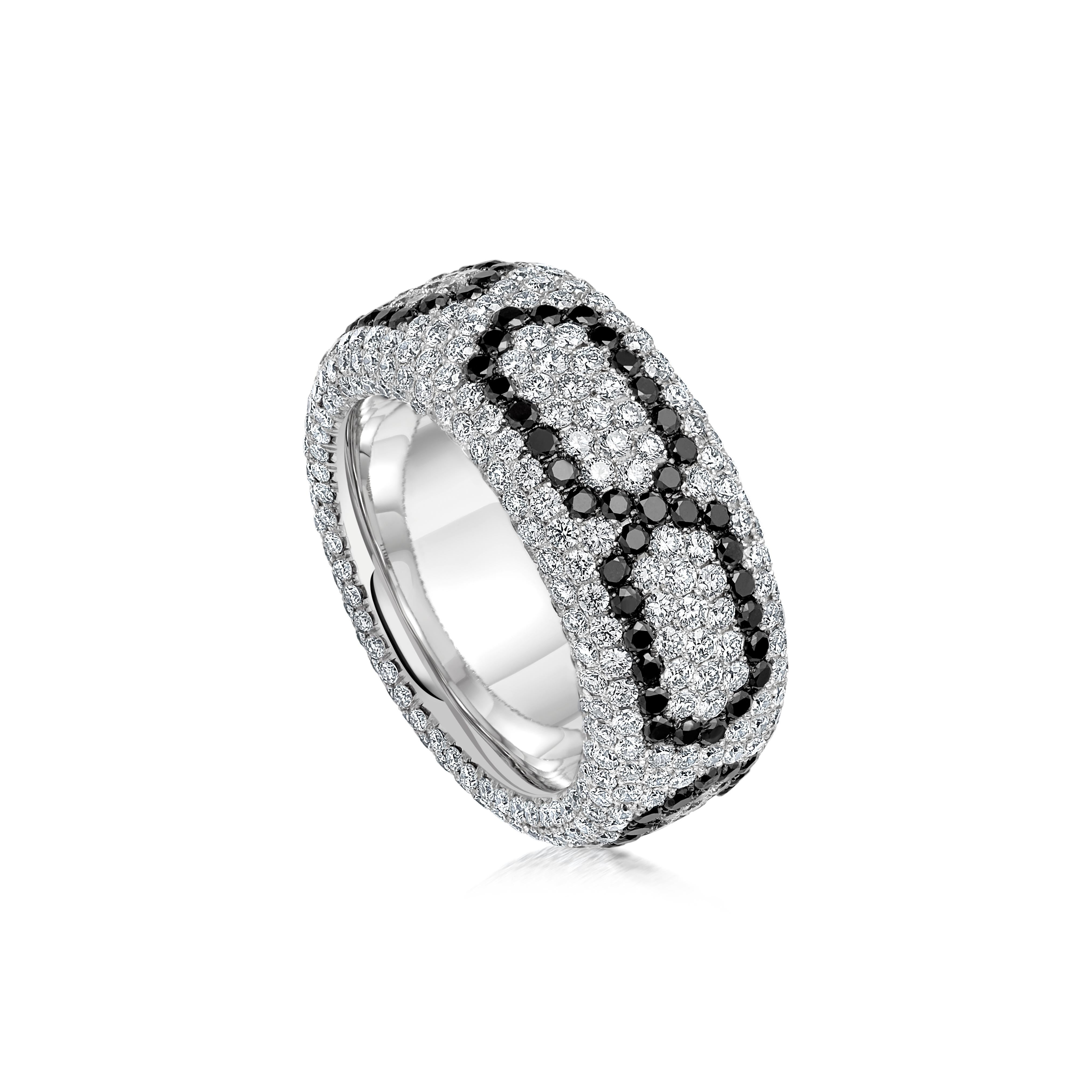 A geometric trail of black diamonds, delicately woven through glistening brilliant cut diamonds, covers the band entirely in a hypnotic pave setting.

Details
Infinity Band Ring
- 18 karat White Gold
- 4.23 carat White Diamond
- 1.28 carat of Black