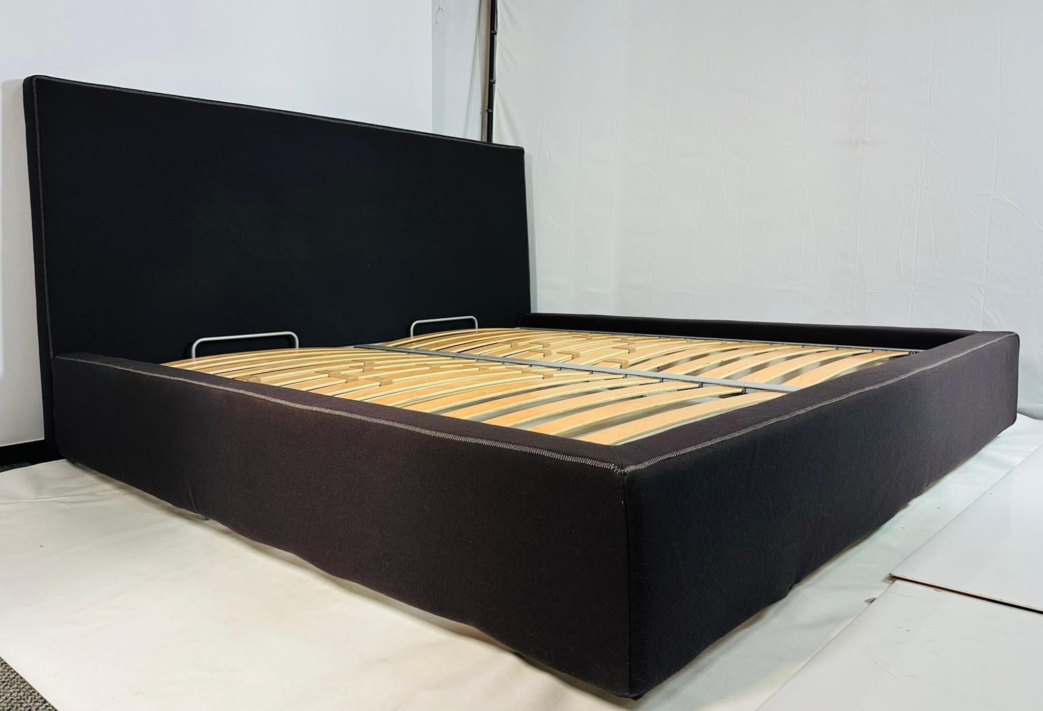 Beautiful king size bed designed by Emaf Progetti and manufactured in Italy by Zanotta.

The piece is fully upholstered with fabric that can be removed for cleaning/washing.

The fabric color is dark brown/chocolate brown.

The bed retains the