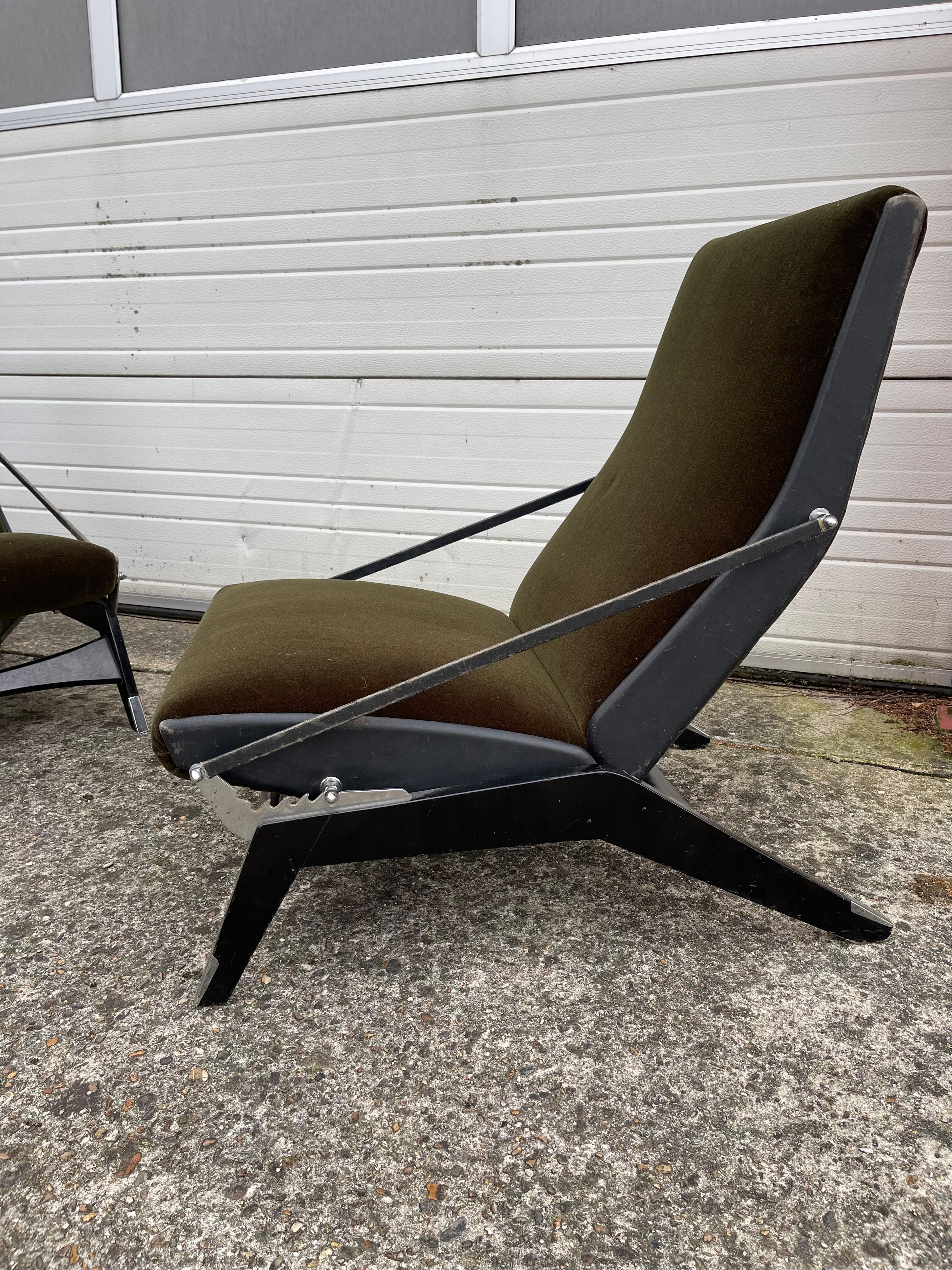Two amazing lounge chairs. Italian design. 50-ies.
Ingeniously  designed. Hard wooden black laquered base holding the newly upholstered seating and back. Upholstery done in dark shade of green velvet. comfortable to the touch. The ármrest' is from a
