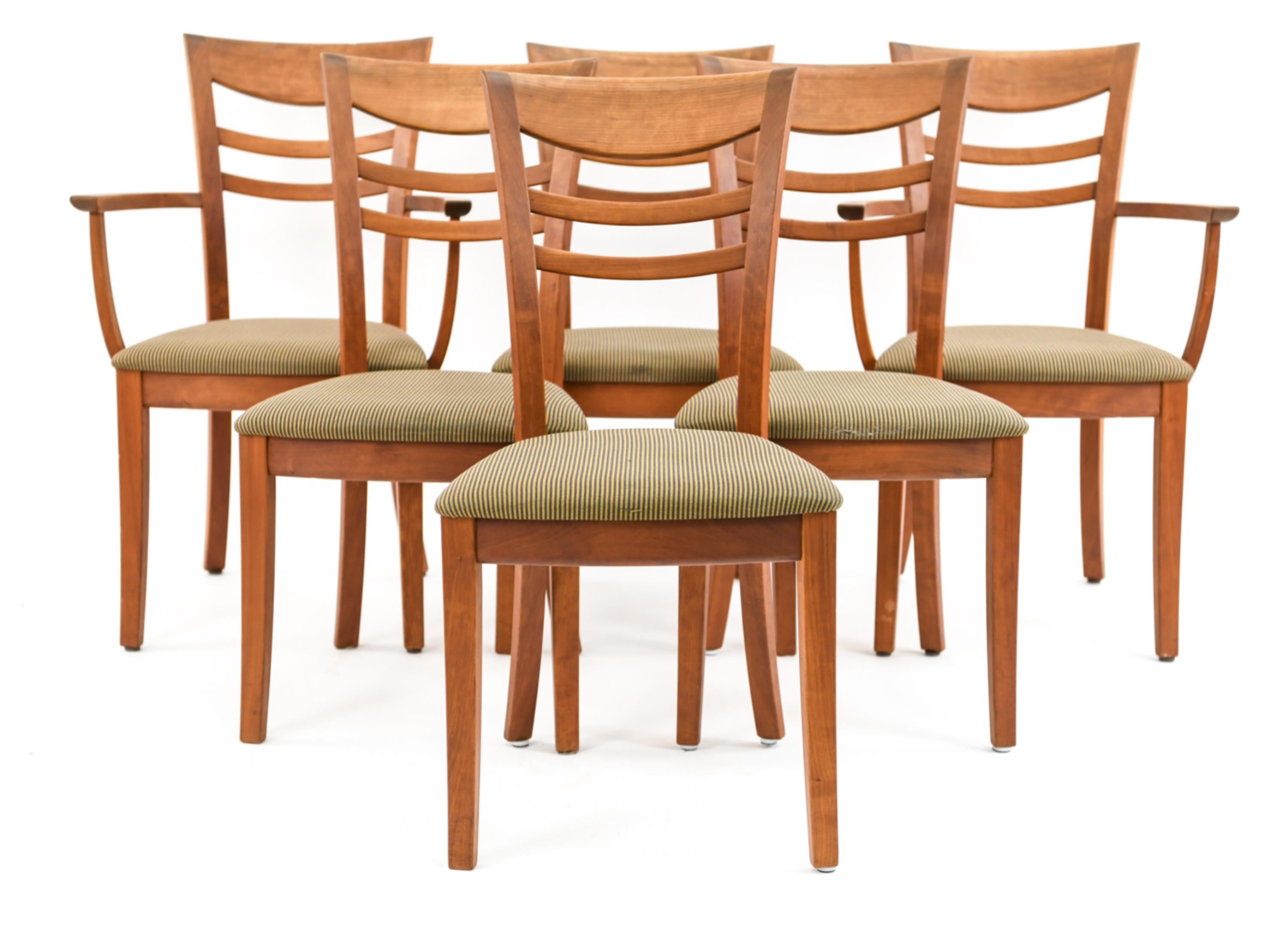 This Danish midcentury dining suite - including a dining table, two armchairs, and four side chairs - was designed by Nissen and Gehl as part of the well-respected Naver collection. The suite features handsome cherrywood and an Art Deco inspired