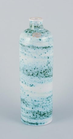 Nittsjö, Sweden, ceramic vase. Green shaded glaze on a white base.