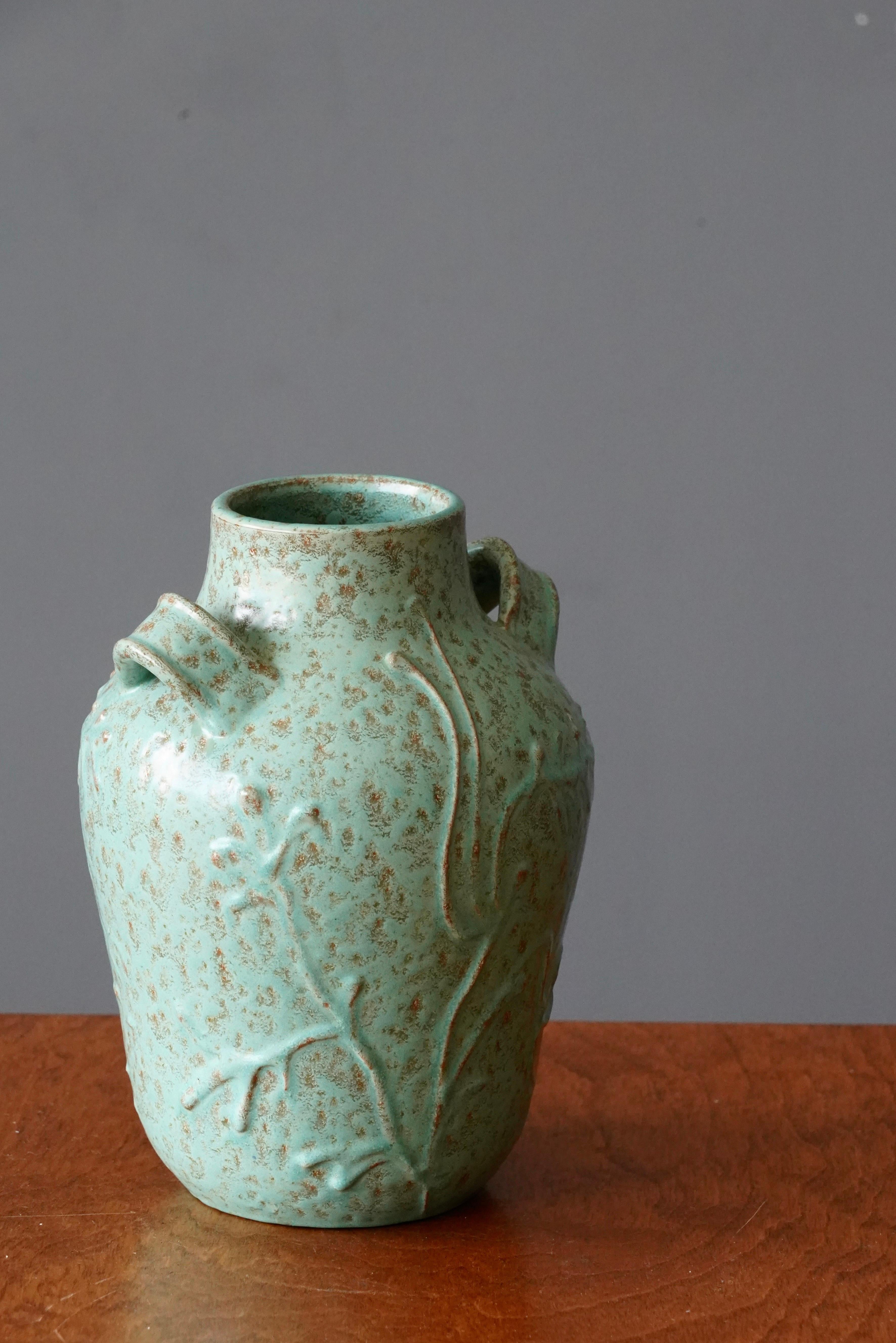 A ceramic vase by Nittsjö. Produced in Sweden, 1940s. Signed. 

With floral relief motifs.

Other designers of the period include Axel Salto, Arne Bang, Wilhelm Kåge, and Gunnar Nylund.
 
