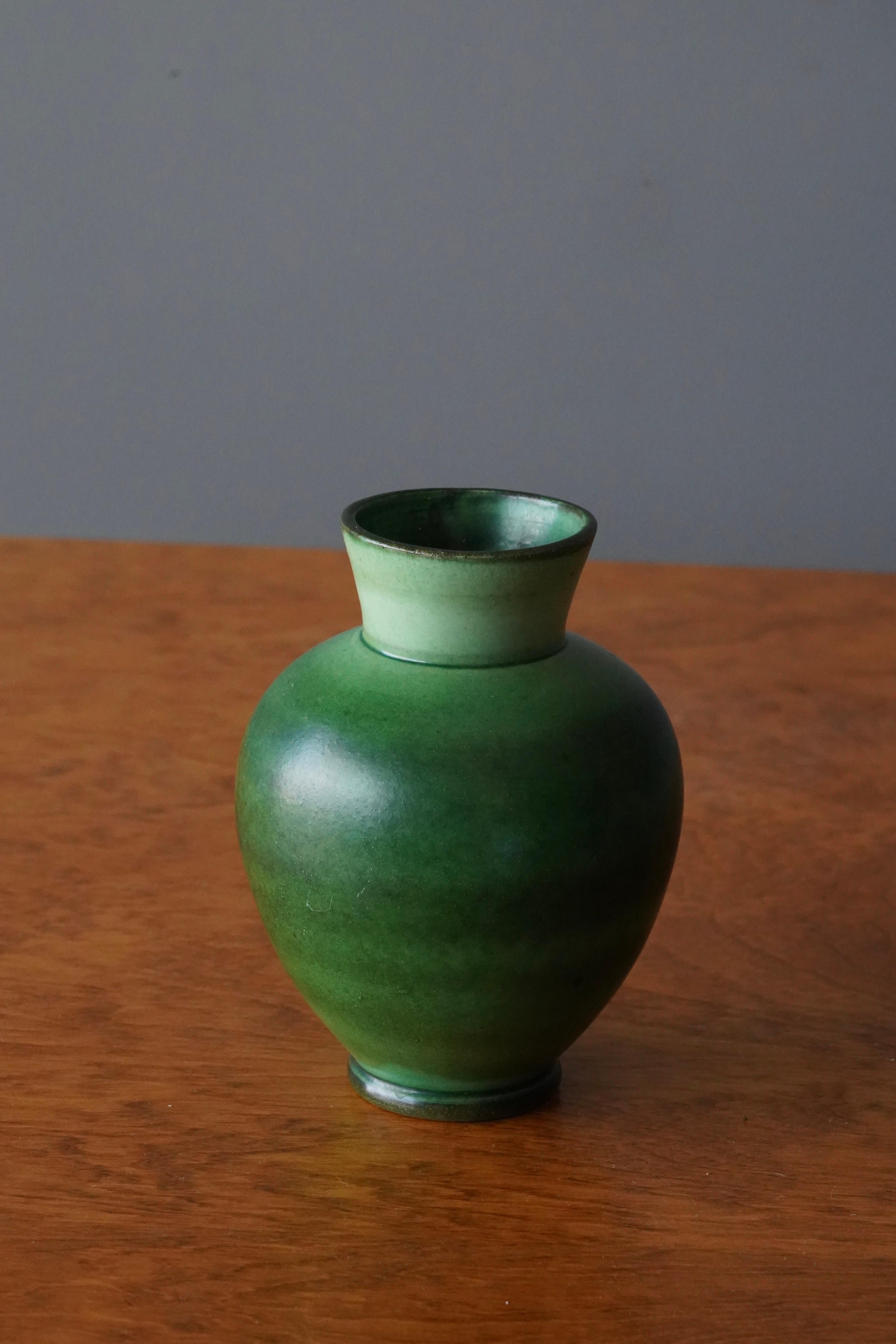 A ceramic vase by Nittsjö. Produced in Sweden, 1940s. Signed. 

In a highly artistic green glaze. Features a sculptural handgrip.

