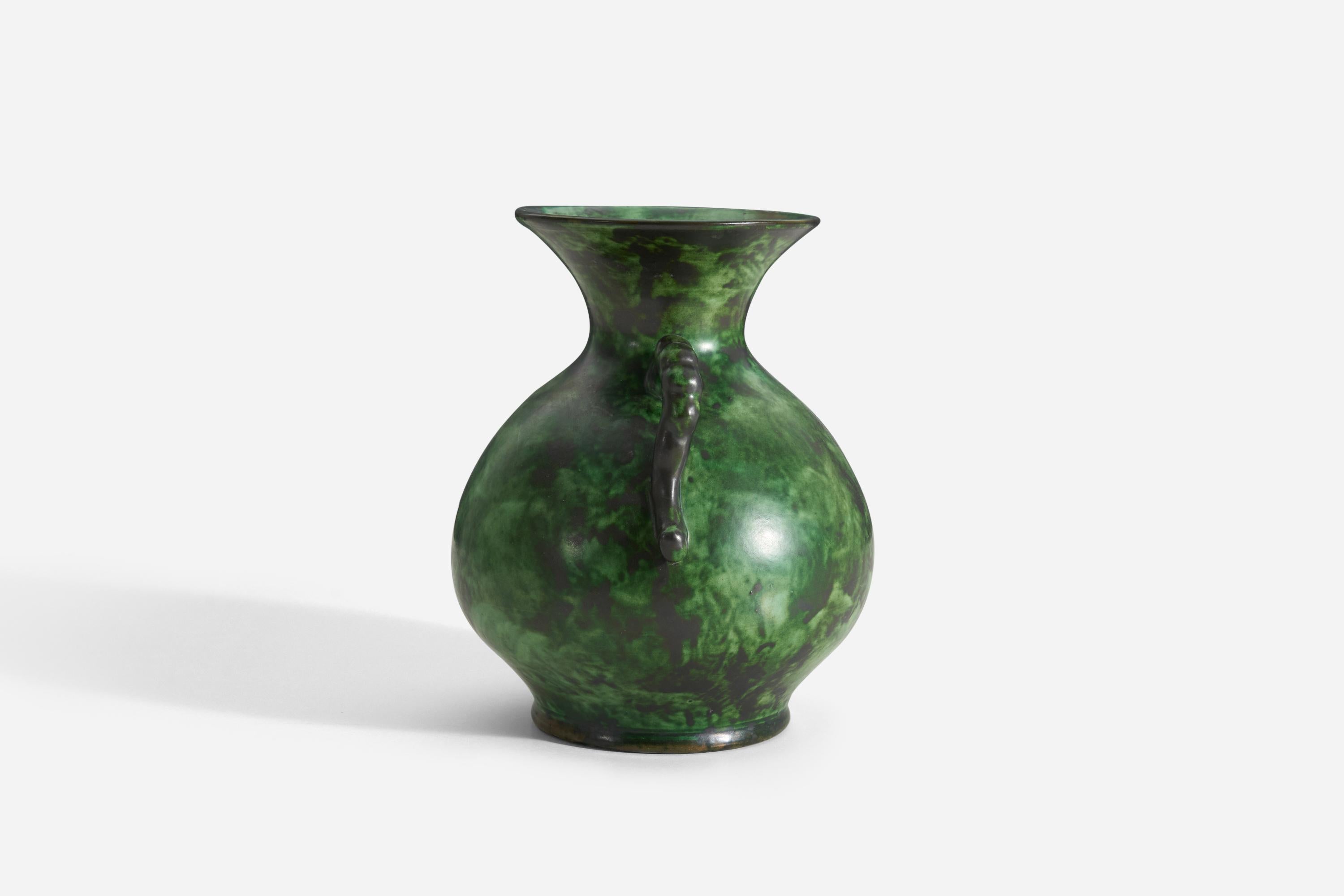 A ceramic vase by Nittsjö. Produced in Sweden, 1940s. Signed. 

In a highly artistic green glaze. Features a sculptural grips.

 