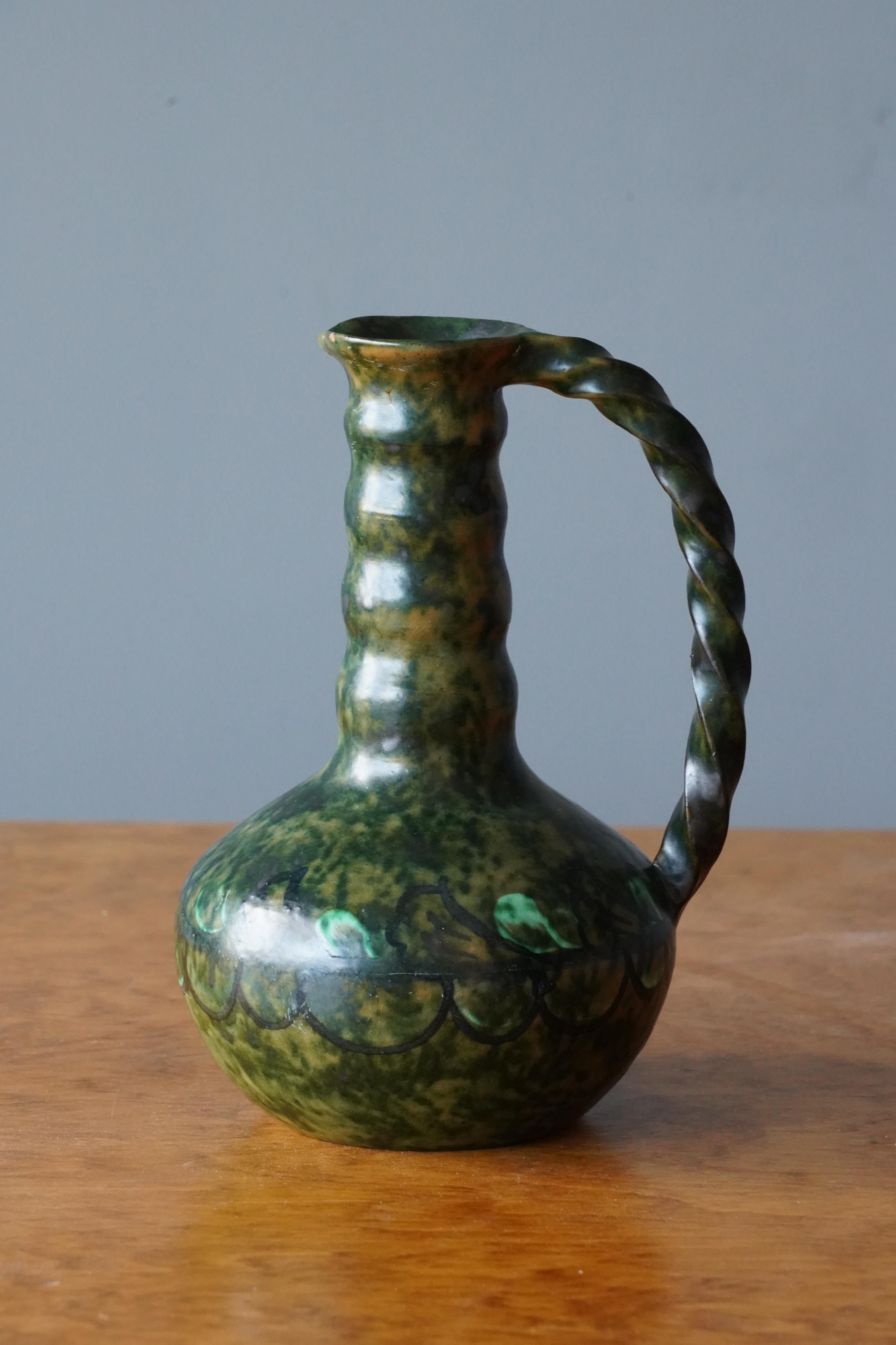 A ceramic vase by Nittsjö. Produced in Sweden, 1940s. Signed. 

In a highly artistic green glaze. Features a sculptural handgrip.

 