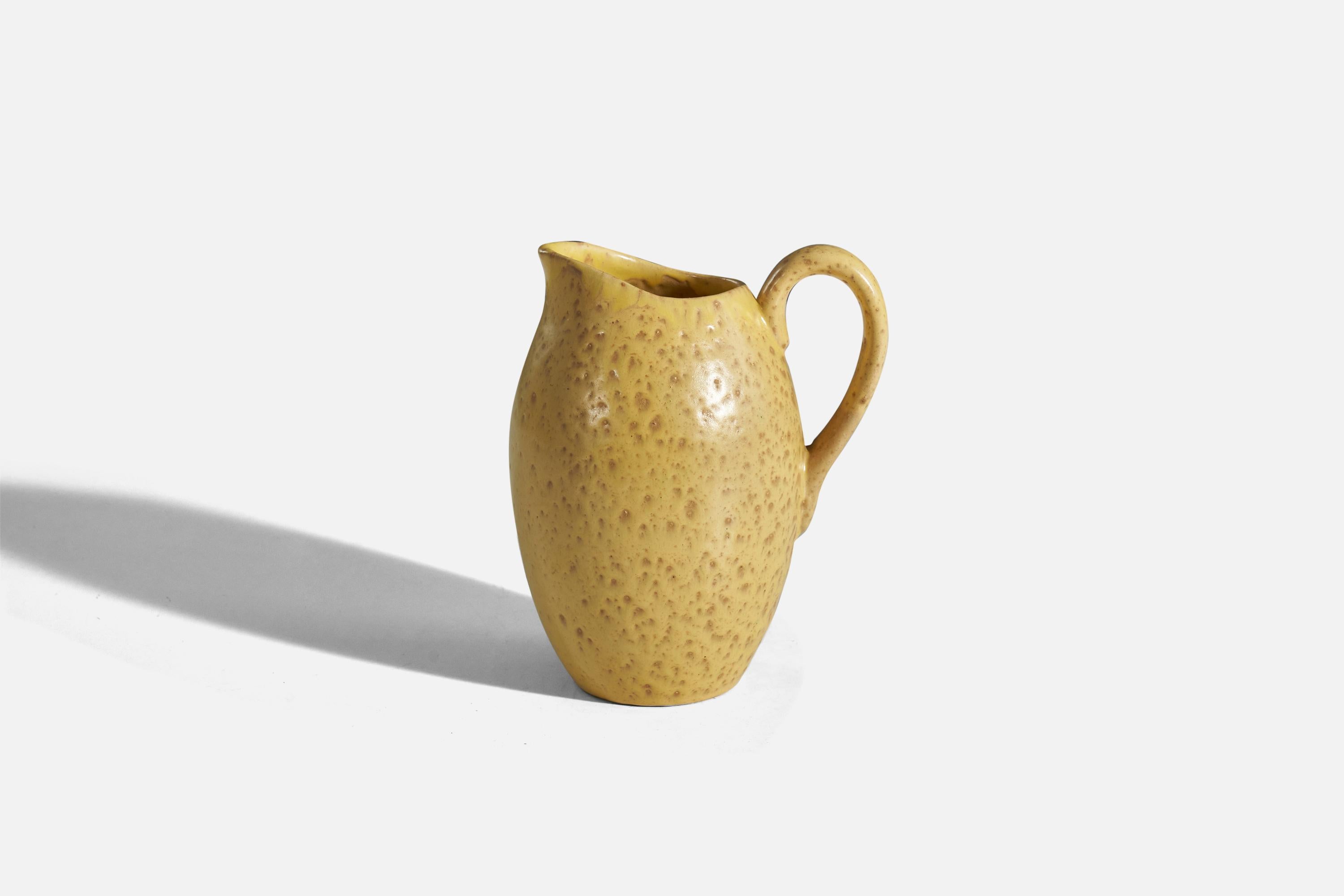 A yellow, glazed earthenware vase or pitcher designed and produced by Nittsjö, Sweden, 1940s.
 