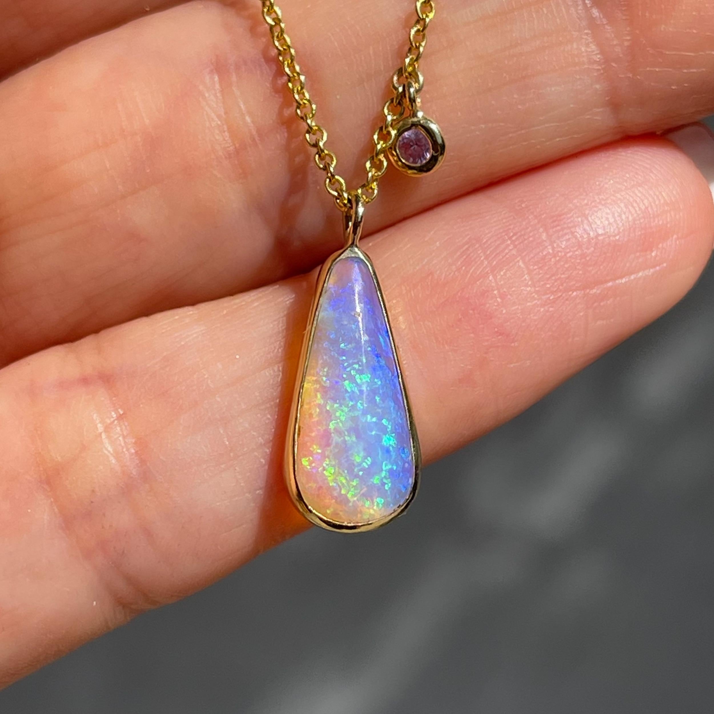 A shimmering pipe opal, aglow with possibility, beams in this Australian Opal Necklace. Three sapphire charms dangle above, and blend sapphire and opal as one. Their shared palette of purple and pink is soft and electric at once. As the rising sun