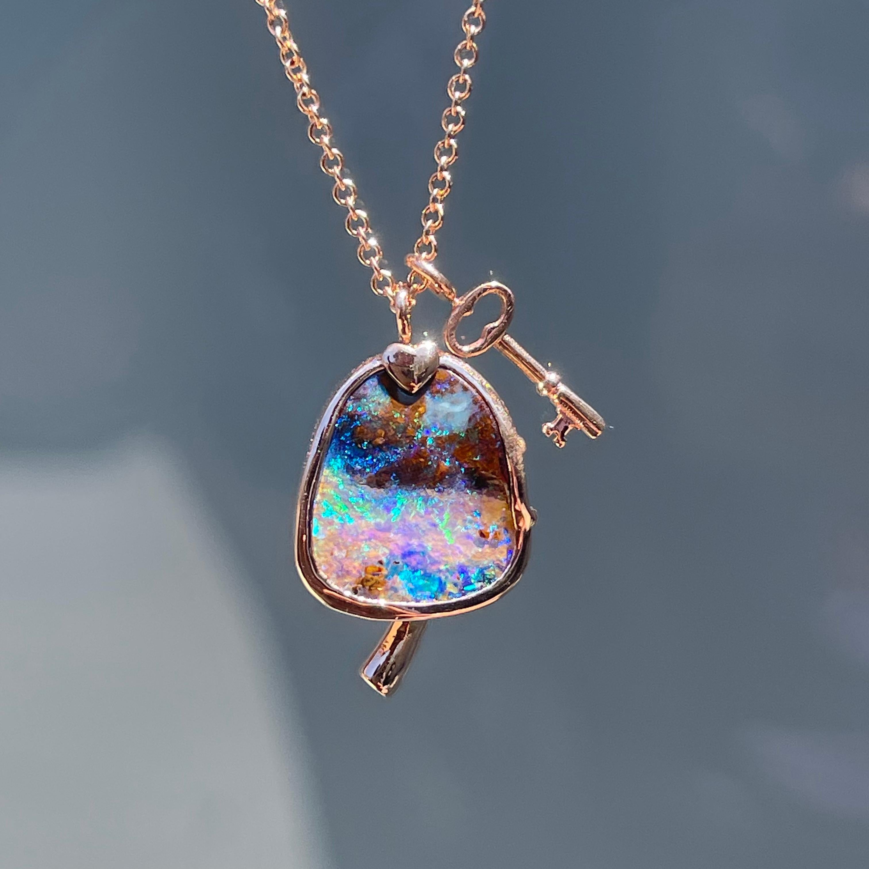 Imagination swells and alchemy manifests in this Australian Opal Necklace. The illusory Boulder Opal conjures greens and blues that pulse across its mushroom cap. A sparkling emerald plugs the stem that emerges from the base of the hypnotic stone.