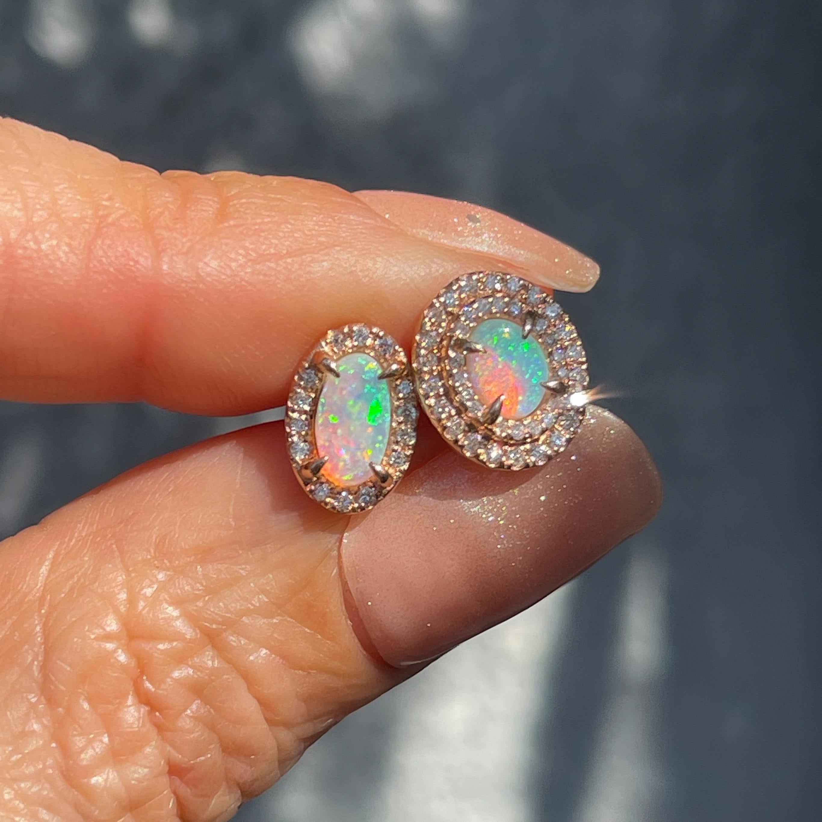 Two entrancing Crystal Opals unite in these Australian Opal Earrings. Set in rose gold and adorned with diamonds, the opal stud earrings exude an air of fantasy. Both oval in shape, yet asymmetrical in dimension, the opals express the same mystical