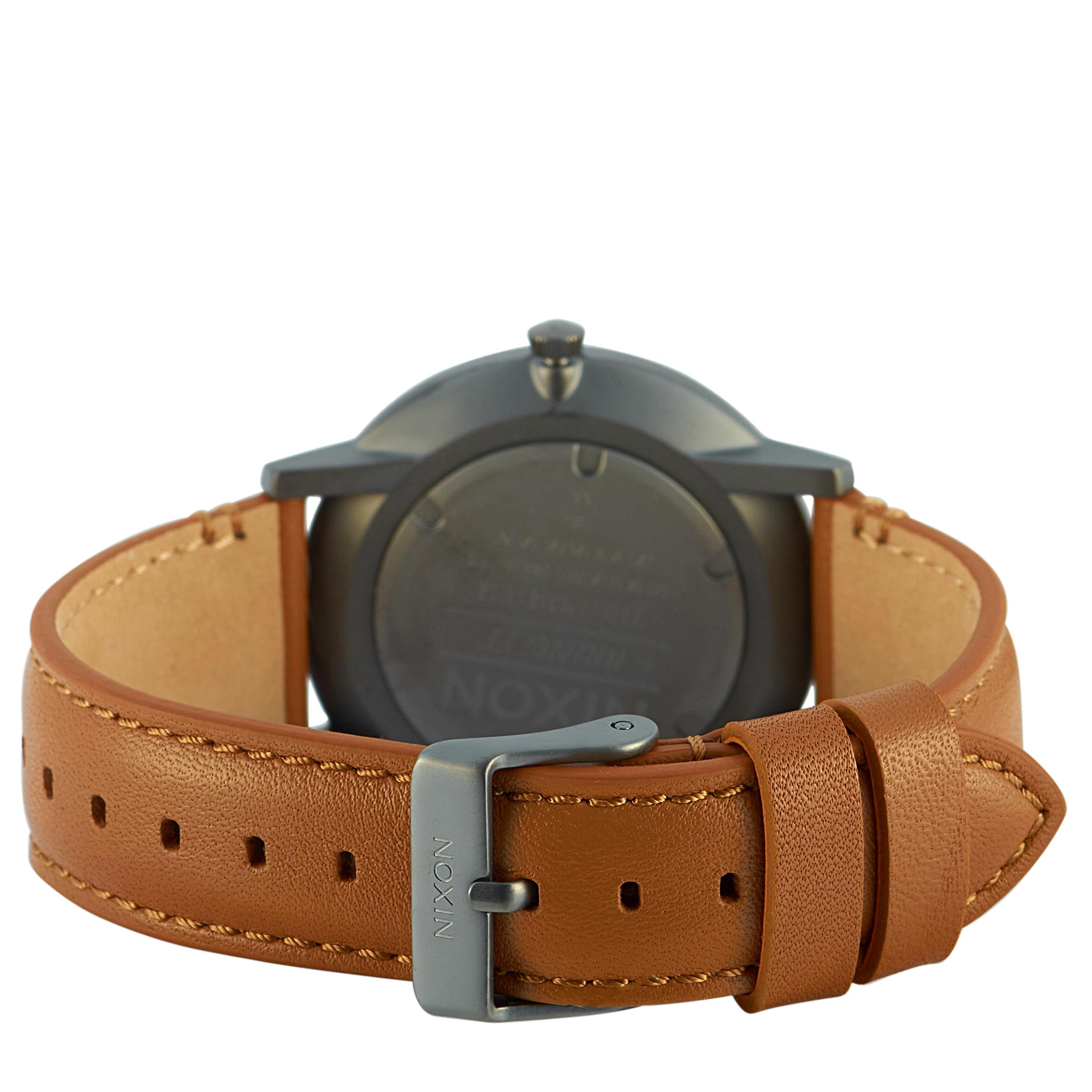 The Nixon Porter Leather Gunmetal/Charcoal/Taupe watch, reference number A1058-2494-00, comes with a 40 mm stainless steel case that is presented on a taupe brown leather strap, secured on the wrist with a tang buckle. The case is water-resistant to