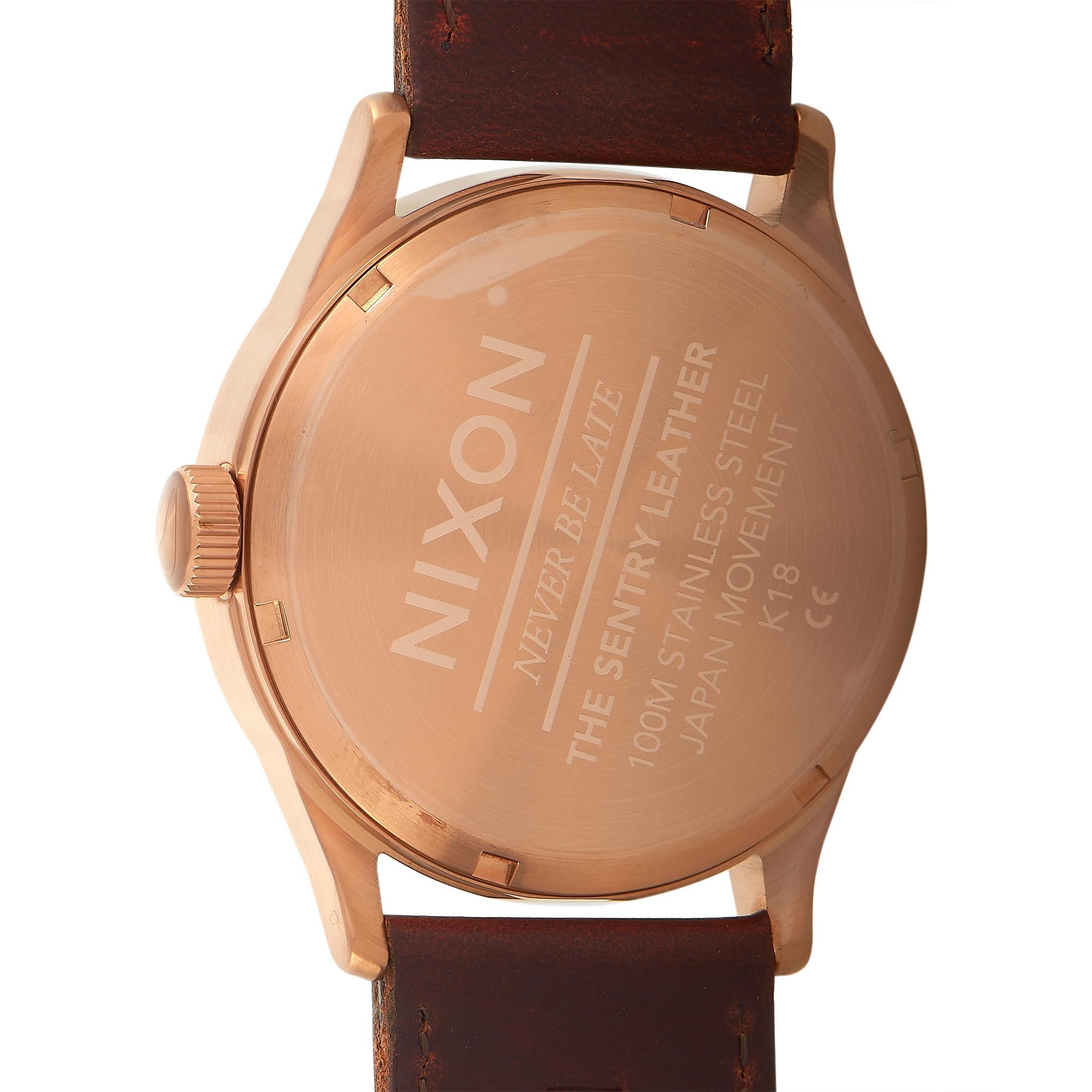 The Nixon Sentry Leather watch, reference number A105-2867-00, comes with a rose gold-tone stainless steel case that measures 42 mm in diameter. The case is presented on a brown leather strap fitted with a tang buckle. This timepiece is equipped