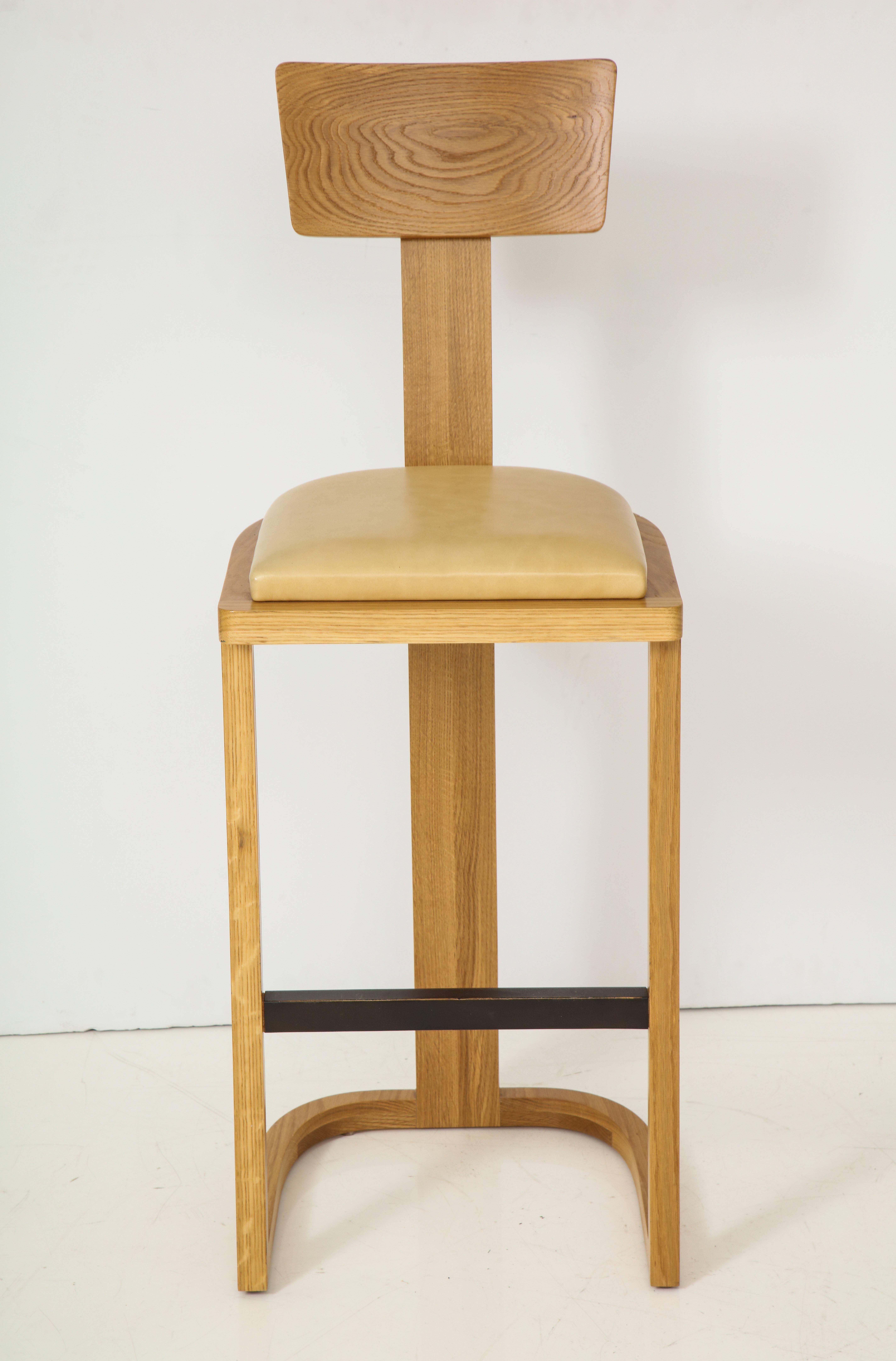 Solid oakwood barstool with U-shaped base and a slightly pitched, T-shaped backrest. Made in Los Angeles.