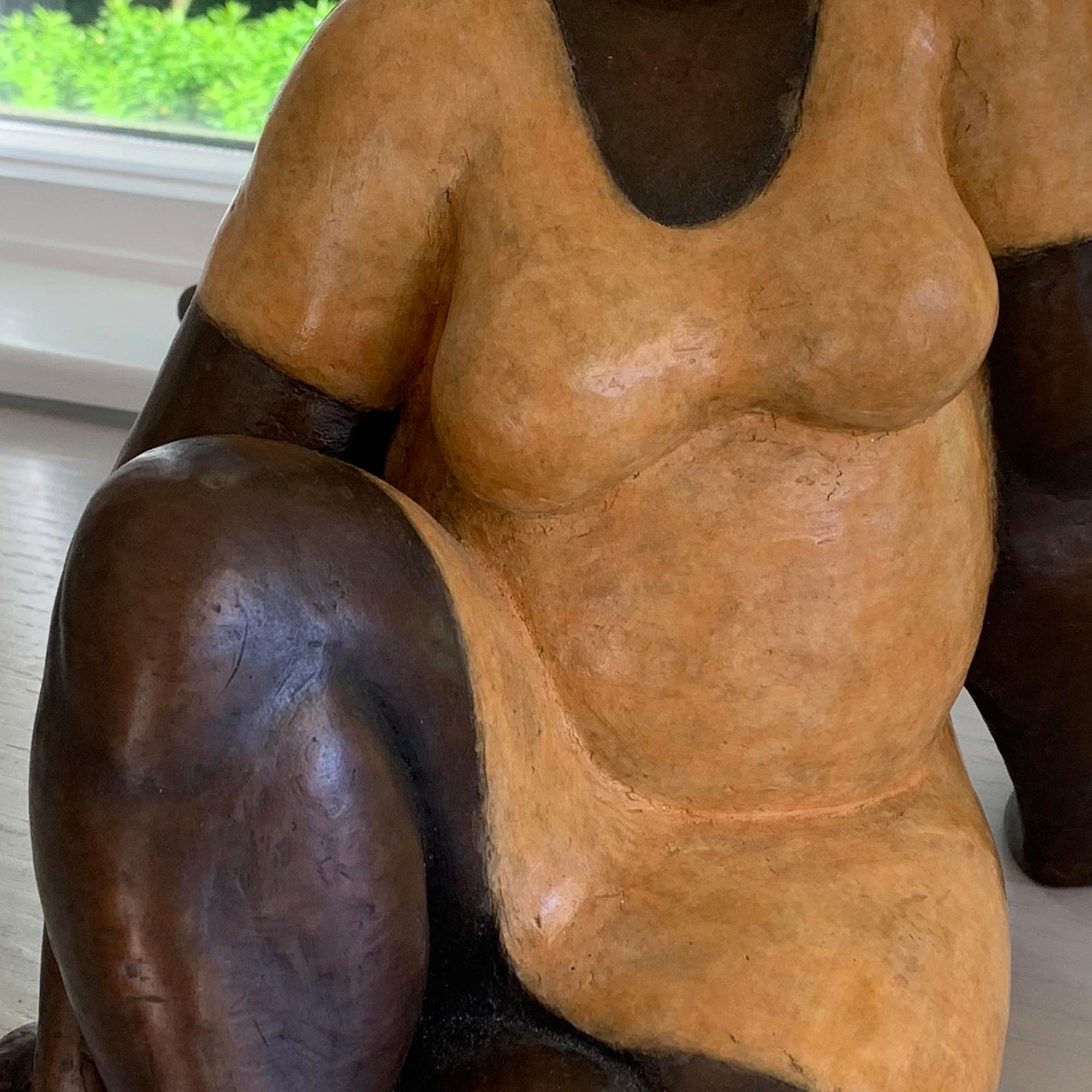 Nnamdi Okowkwo's stylized seated woman in an attitude of tranquility. To create it, he first sculpts the figure in clay, then casts it in bronze using the lost wax technique. A hot patina is applied using compounds that are specifically formulated