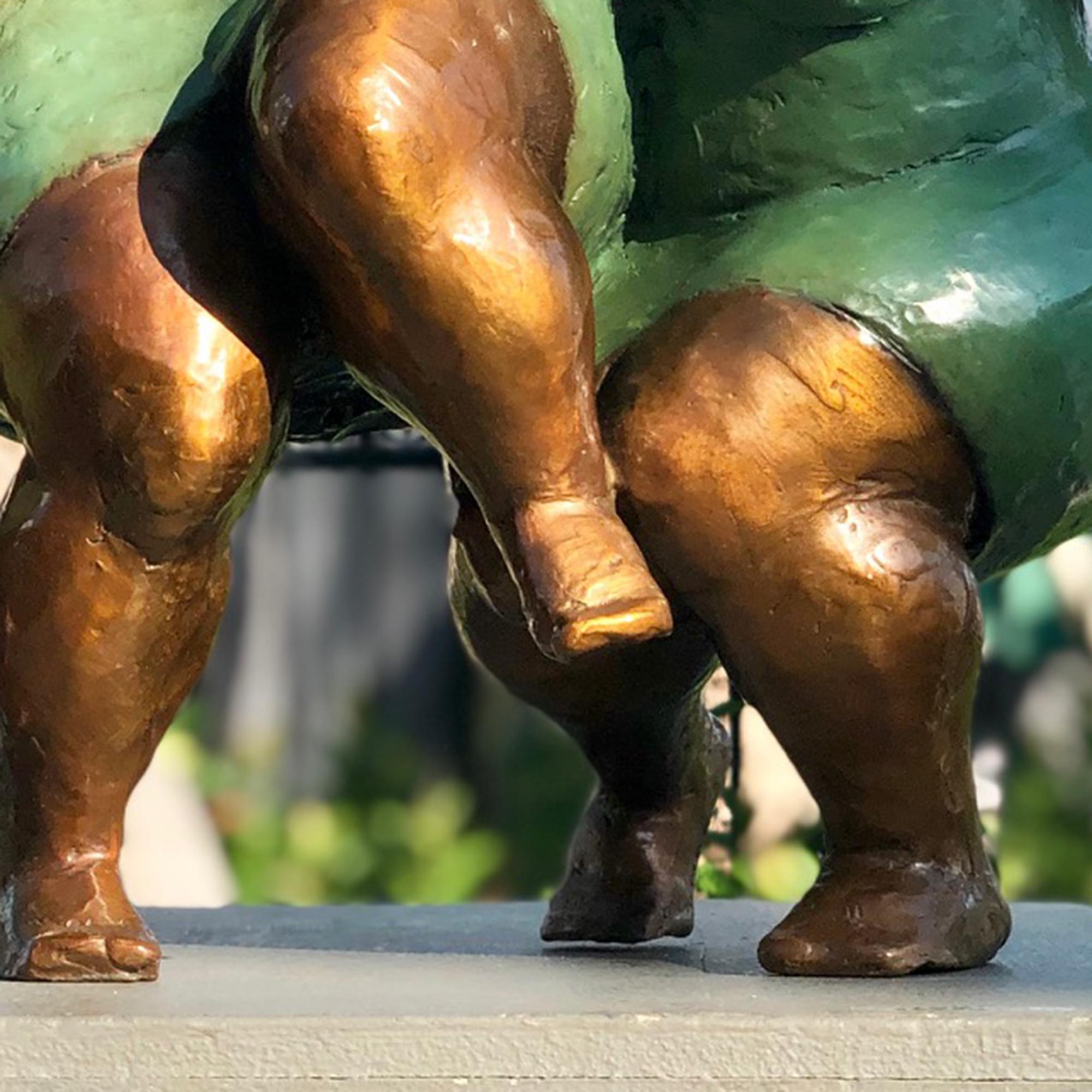 Nnamdi Okonkwo's stylized sculptures of women capture the pure joy of friendship and sisterhood. To create it, he first sculpts the figure in clay, then casts it in bronze using the lost wax technique. A hot patina is applied using compounds that