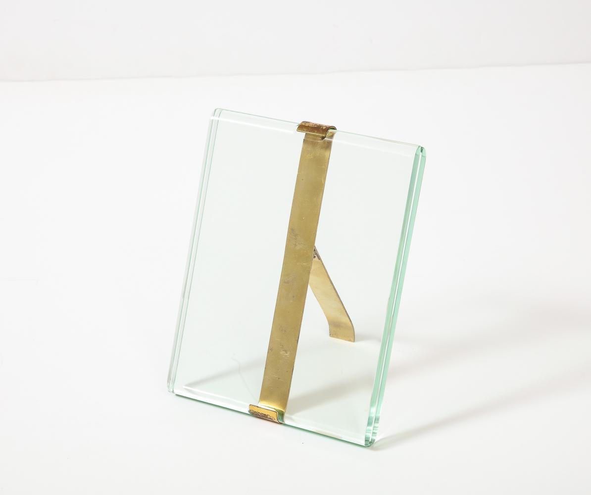 Glass and brass. Rare tabletop frame designed by Pietro Chiesa for Fontana Arte. Elegant polished crystal panels with brass-banded fittings and stand.
 Horizontal version also available.