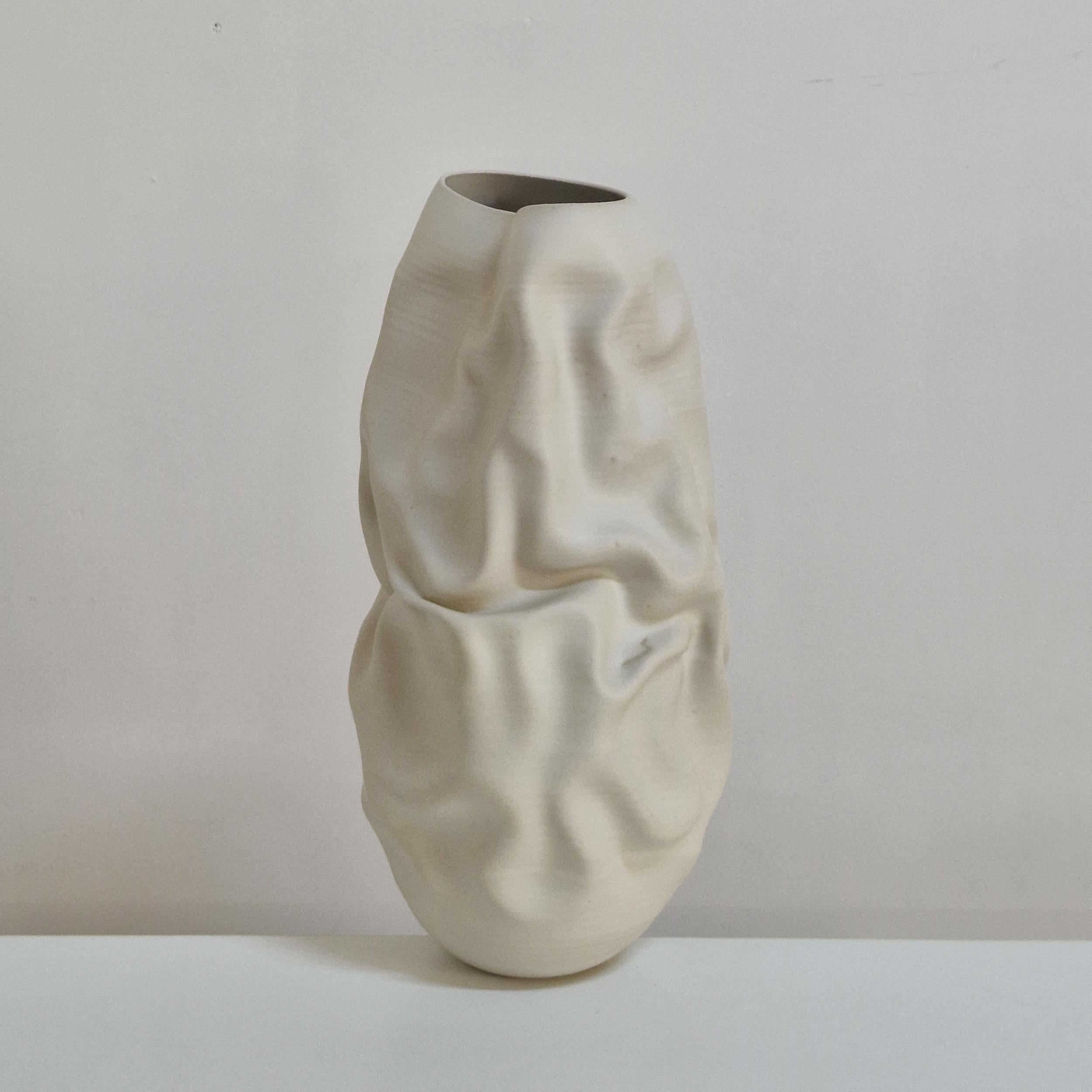 Vessel No. 163 white irregular form vessel by ceramic artist Nicholas Arroyave-Portela. 

Materials: White St. Thomas clay, stoneware glazes, multi fired to cone 9 (1260 degrees) 

Made in 2025

Dimensions: 49 cm tall, 22 cm wide, 23 cm deep / 19.29