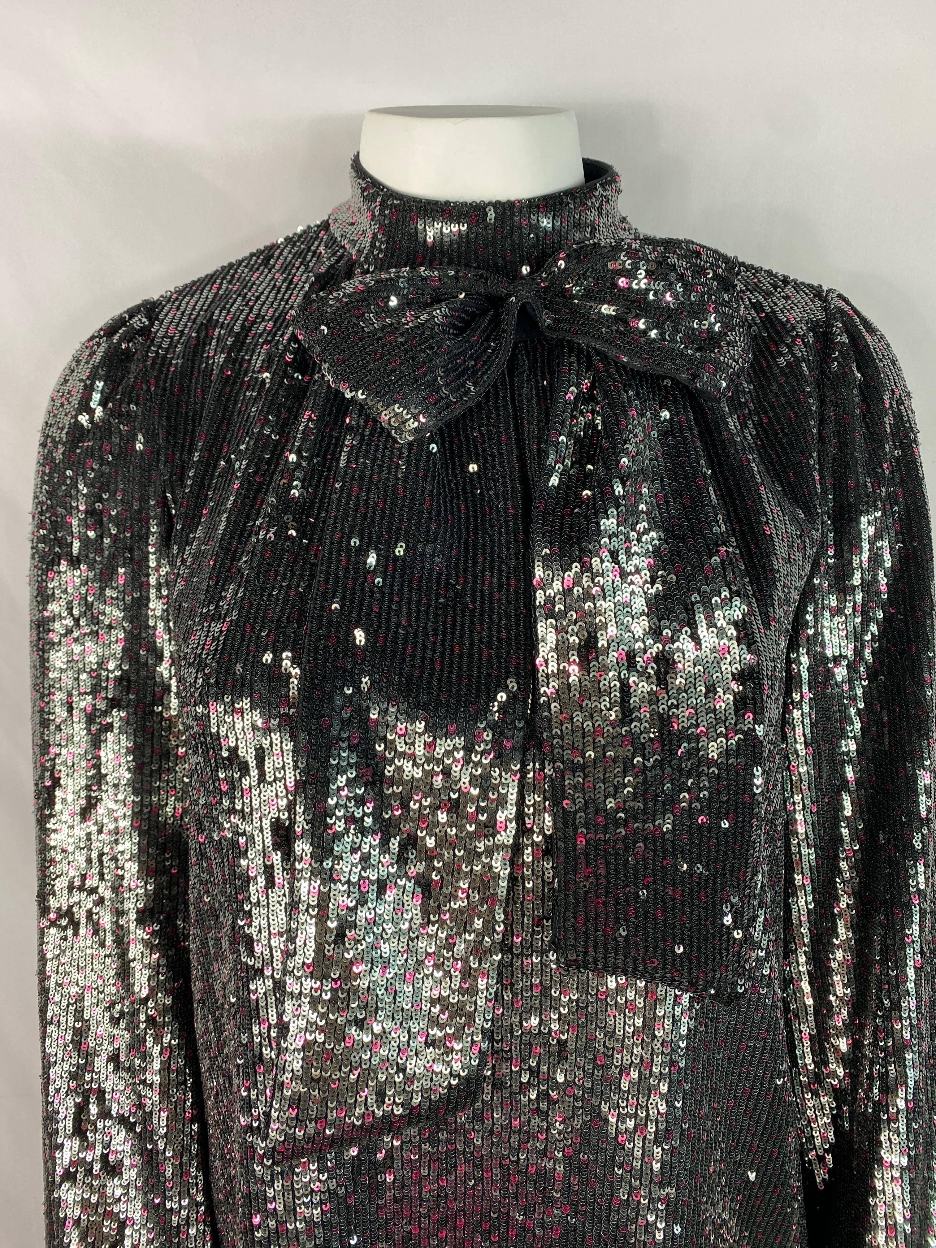 Product details:

Shiny grey and pink sequin mini dress designed by Italian company No. 21. The dress features, low turtle neck with large bow detail and rear three button closure.
Made in Italy.