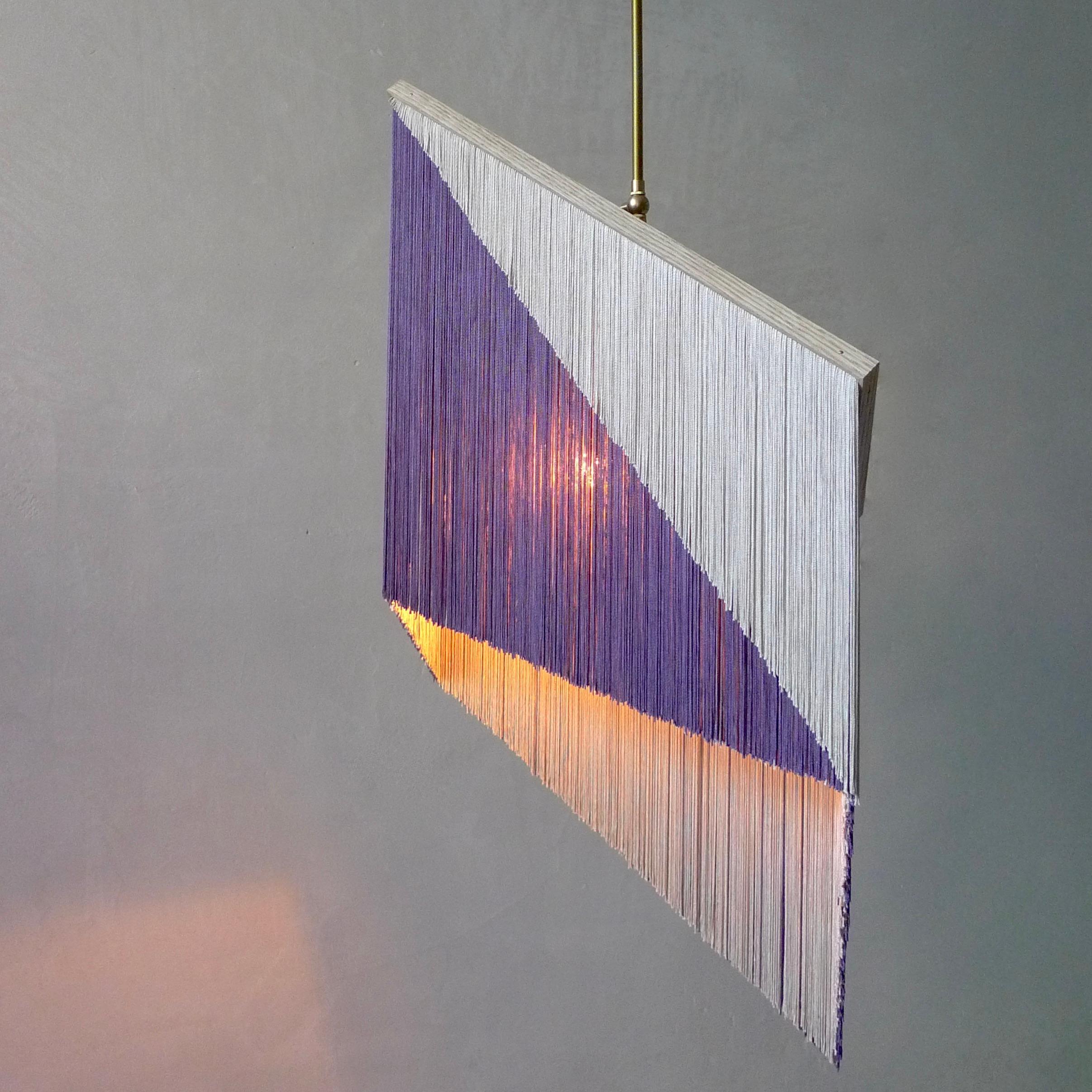 No. 26 Pendant Lamp by Sander Bottinga
Objet size 4
Dimensions: H 46 - 90 x W 51 x D 20 cm
Materials: Brass, Wood, Leather, Viscose Fringes
Variations available.

Handmade in brass, wood, leather and 3 double layered viscose fringes in
geometric cut